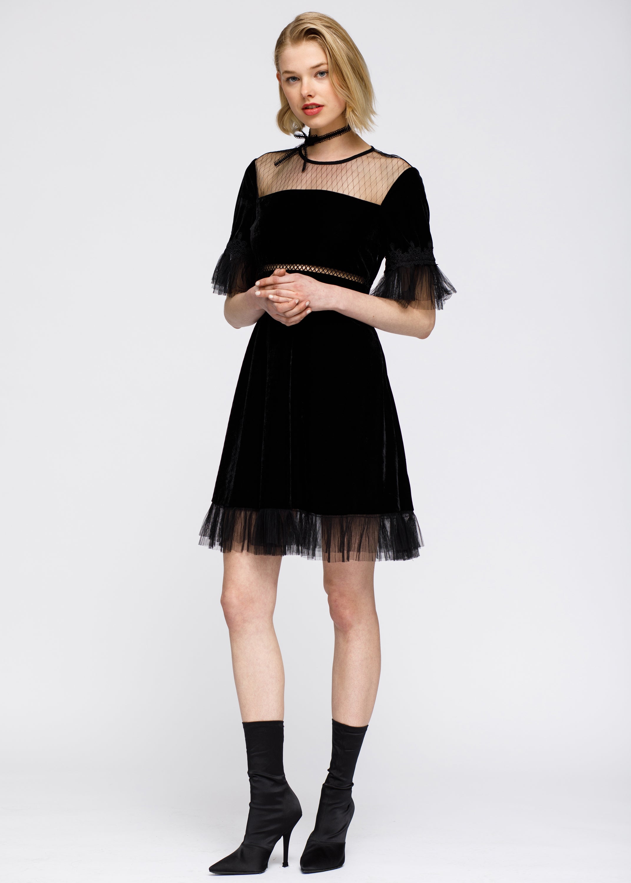 Women's black mesh contrast velvet dress featuring lace trim at sleeves and hem, back button closure, and hidden side zipper.