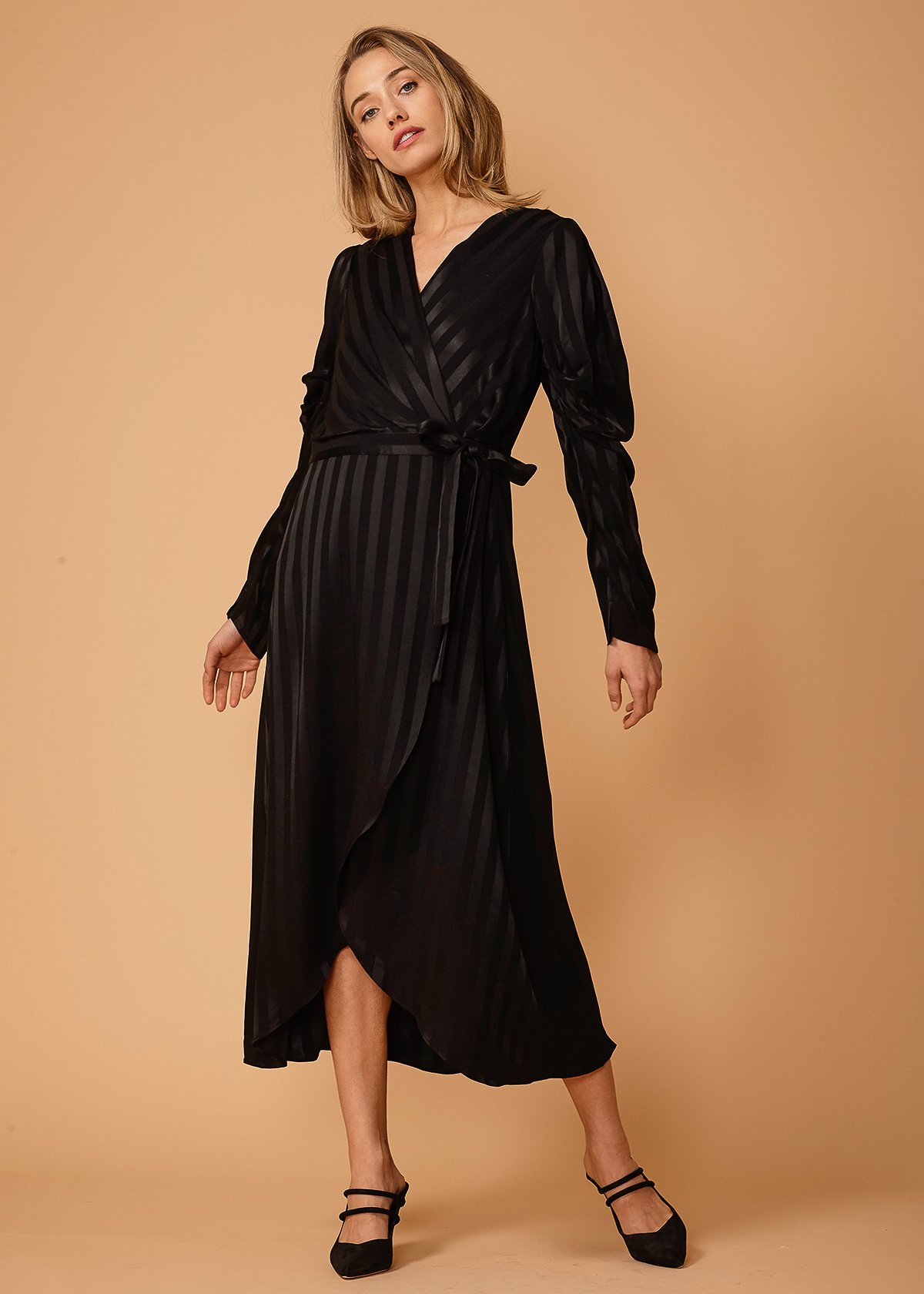 Women's black stripe dress featuring puffy pleated sleeves and a wrap waist, elegantly styled for various occasions.