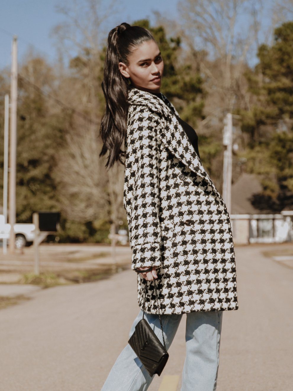 Arlo Oversized Houndstooth Coat featuring a classic print, oversized sleeves, and a detachable belt, styled elegantly over a dress.