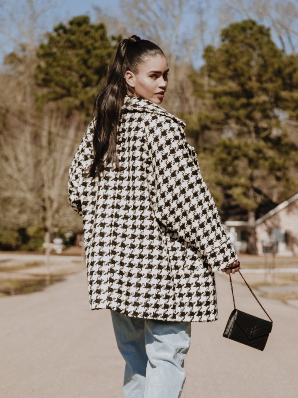 Arlo Oversized Houndstooth Coat featuring a classic print, oversized sleeves, and a detachable belt, styled elegantly over a dress.