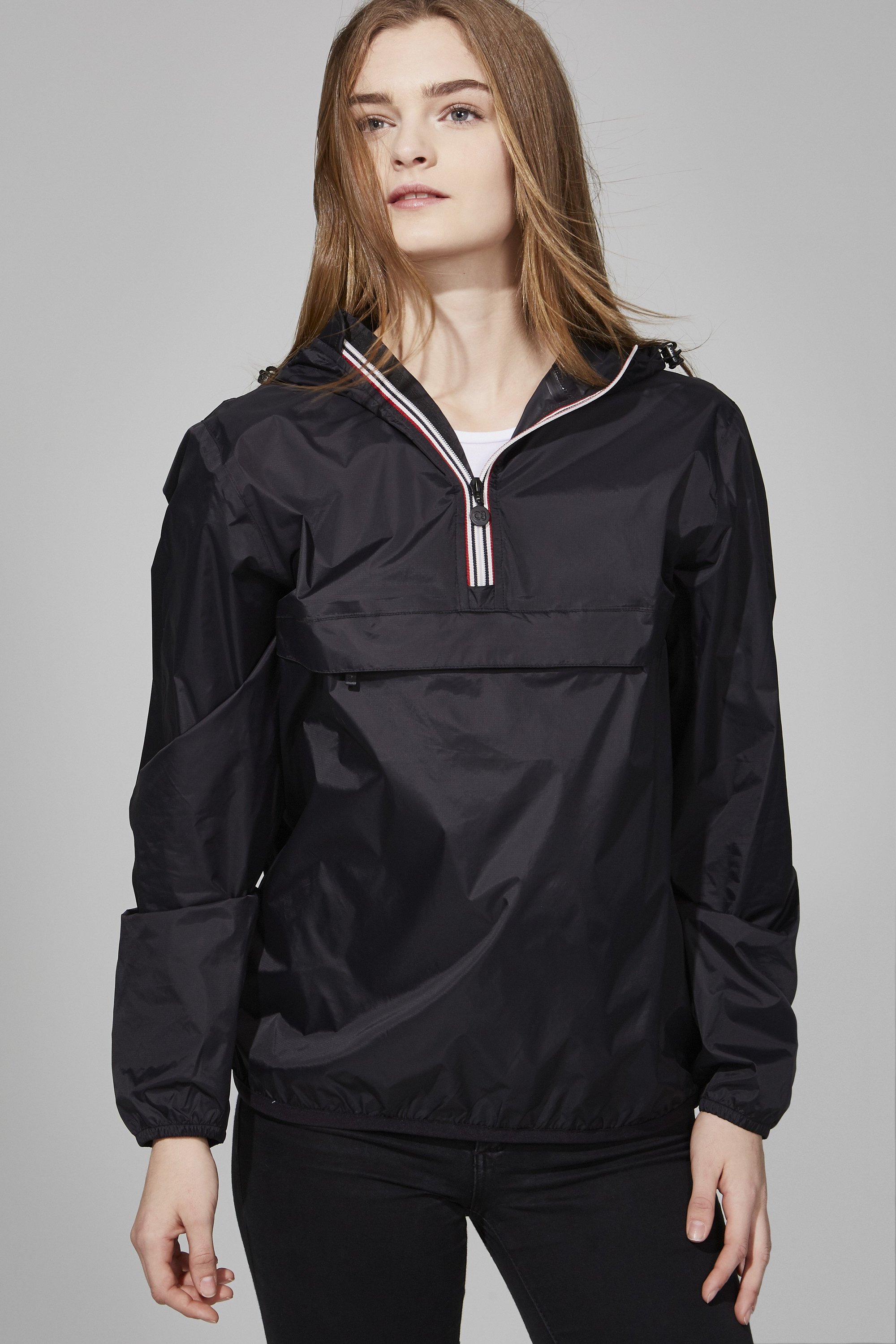 Black quarter zip packable rain jacket with heat-sealed seams, showcasing its compact design and hook clip.