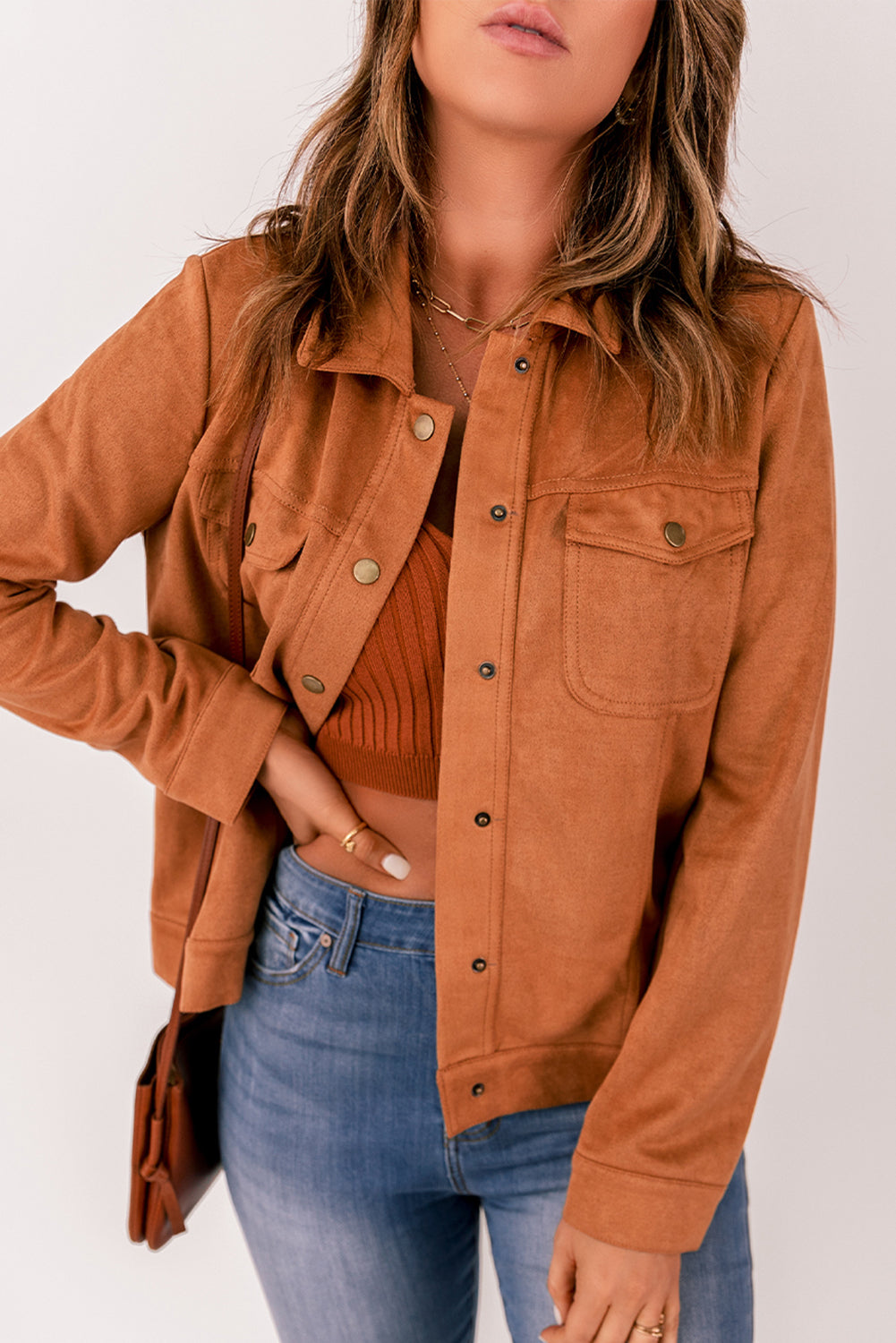 Brown suede jacket with flap pockets and snap button closure, perfect for winter wear.