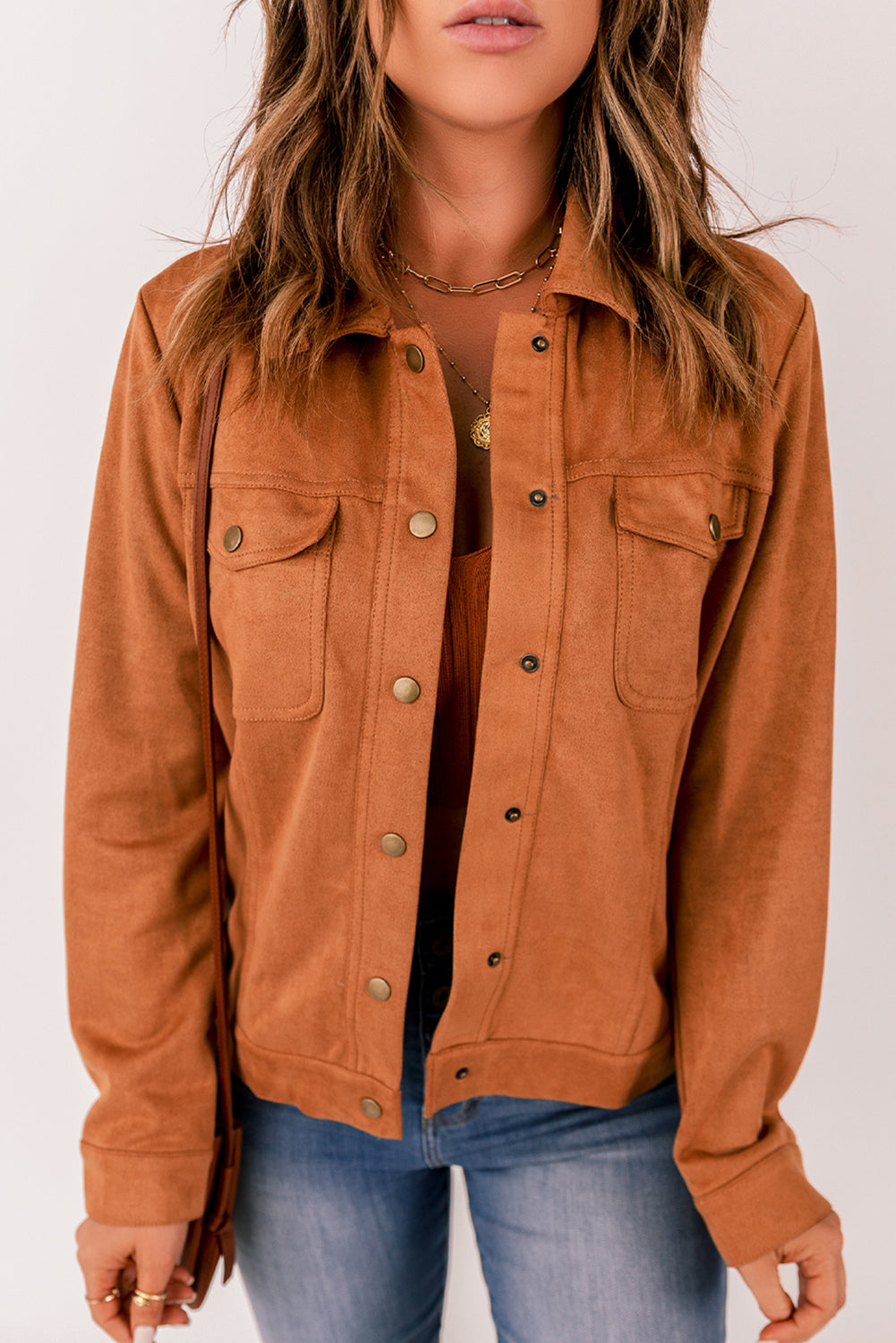 Brown suede jacket with flap pockets and snap button closure, perfect for winter wear.
