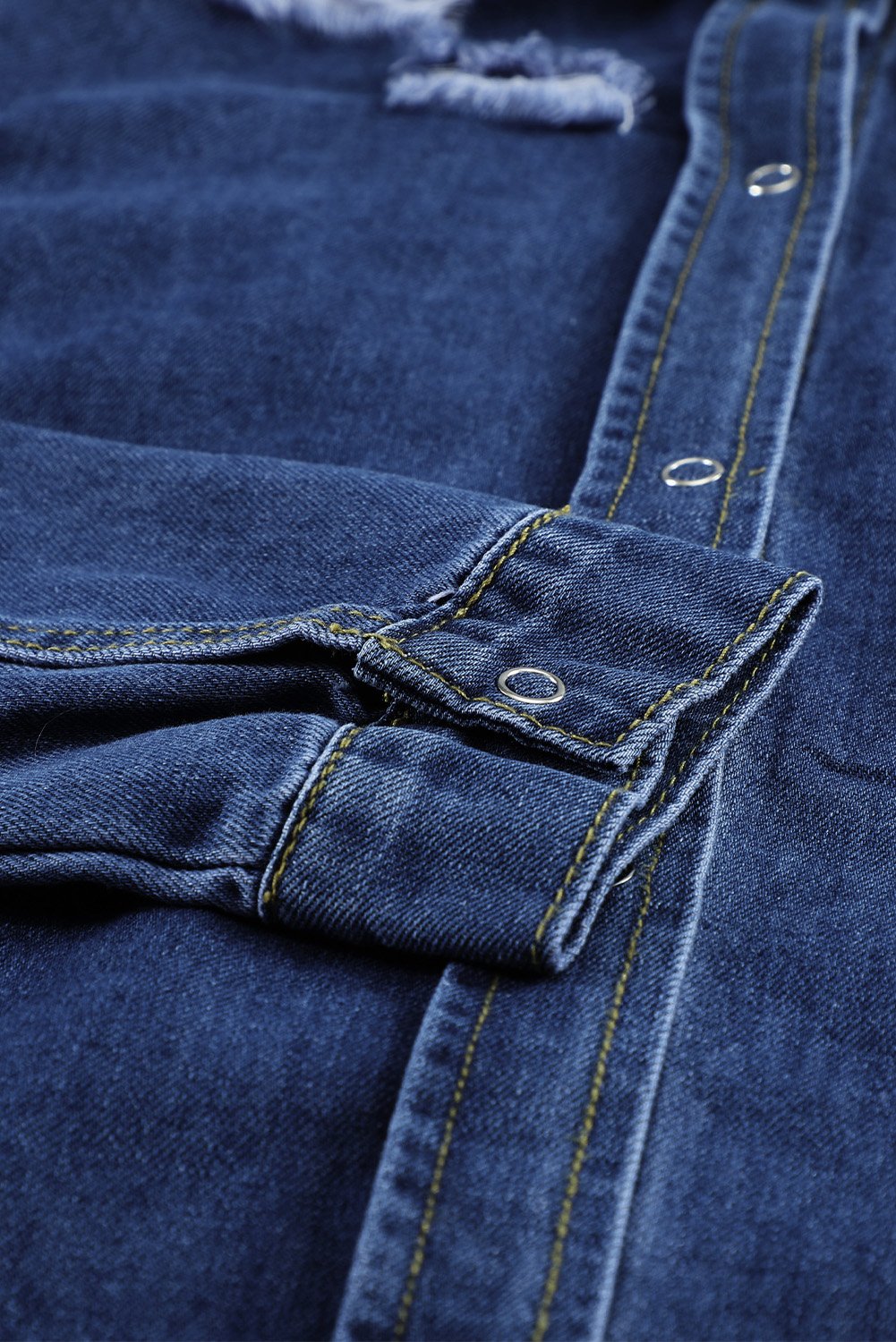 Dark blue jeans shacket with elegant collar and distressed design, featuring button closure and pockets.