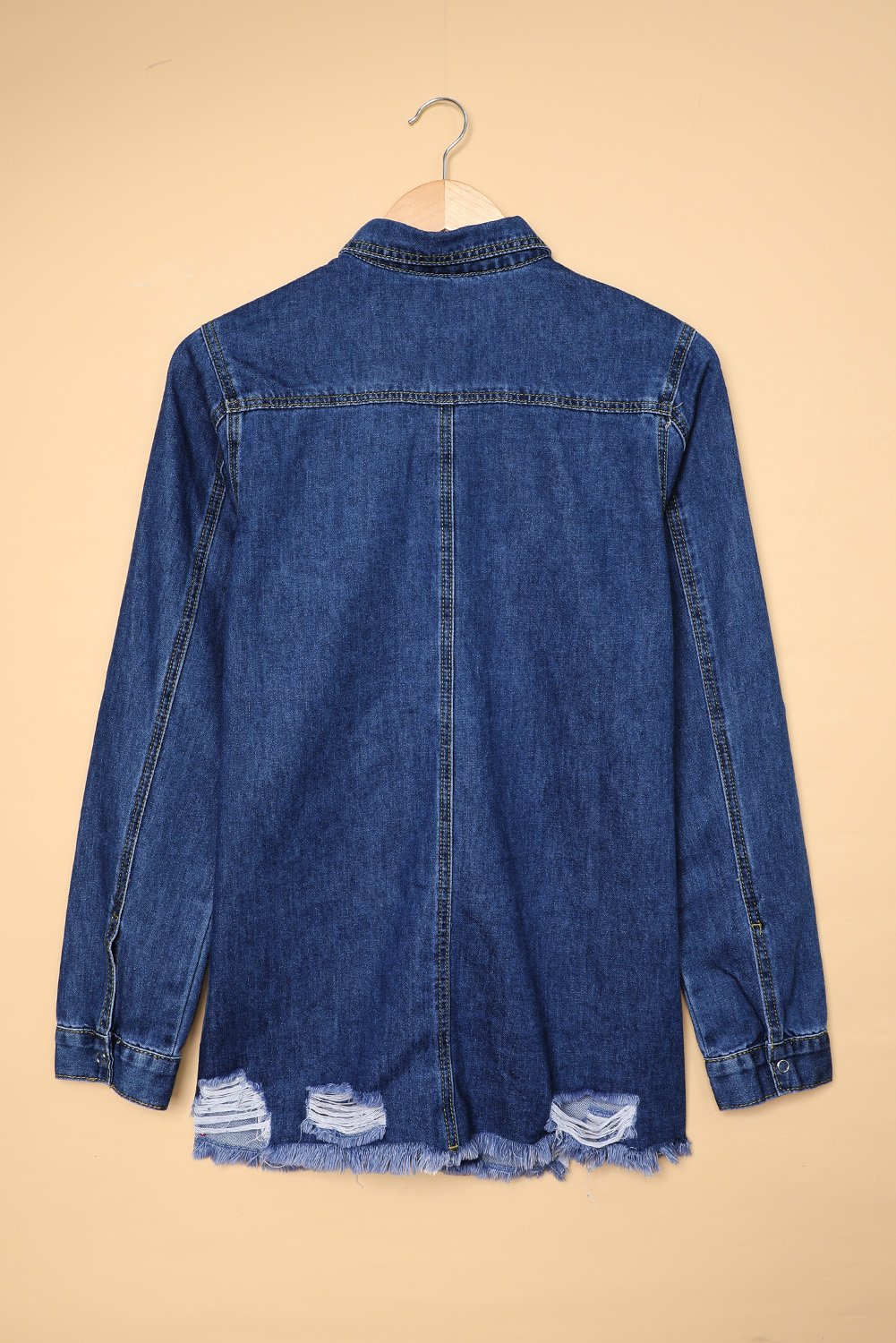 Dark blue jeans shacket with elegant collar and distressed design, featuring button closure and pockets.