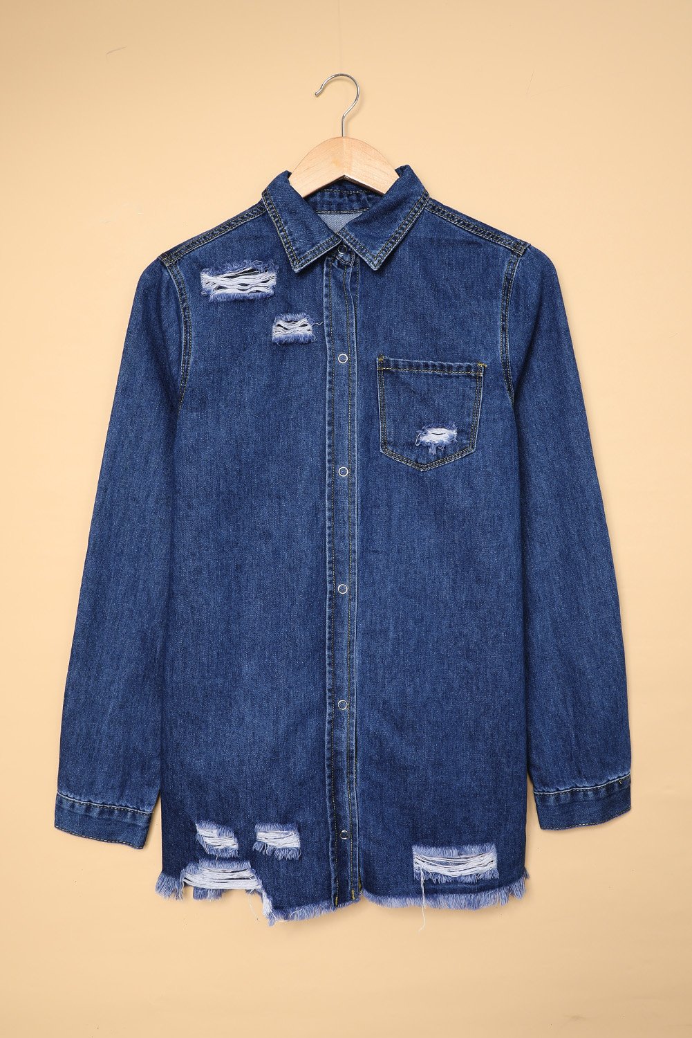 Dark blue jeans shacket with elegant collar and distressed design, featuring button closure and pockets.