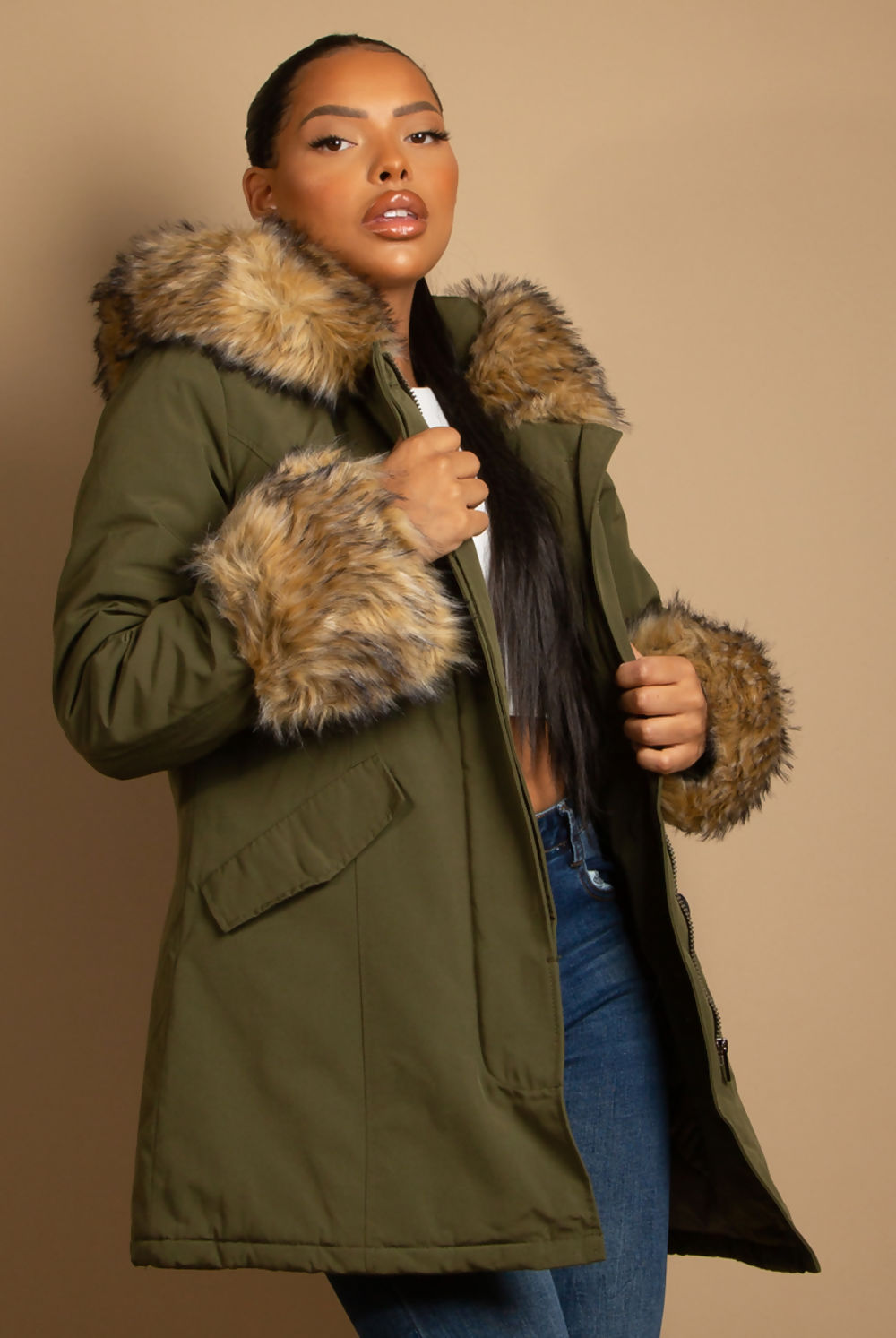 A stylish hooded parka coat featuring chunky faux fur cuffs and hood, perfect for winter layering.