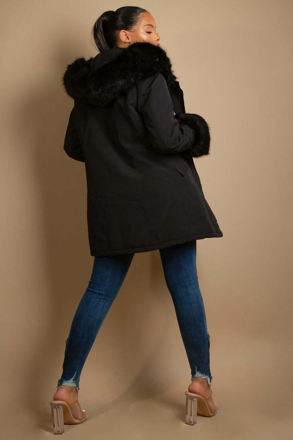 A stylish hooded parka coat featuring chunky faux fur cuffs and hood, perfect for winter layering.