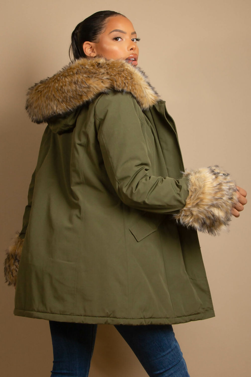 A stylish hooded parka coat featuring chunky faux fur cuffs and hood, perfect for winter layering.