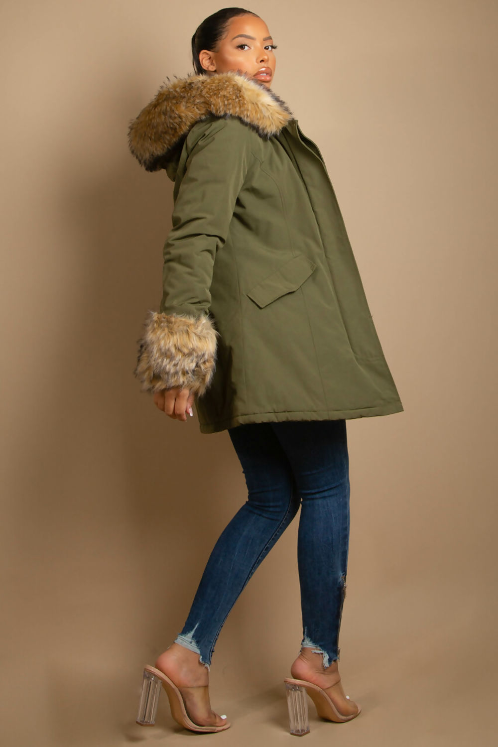 A stylish hooded parka coat featuring chunky faux fur cuffs and hood, perfect for winter layering.