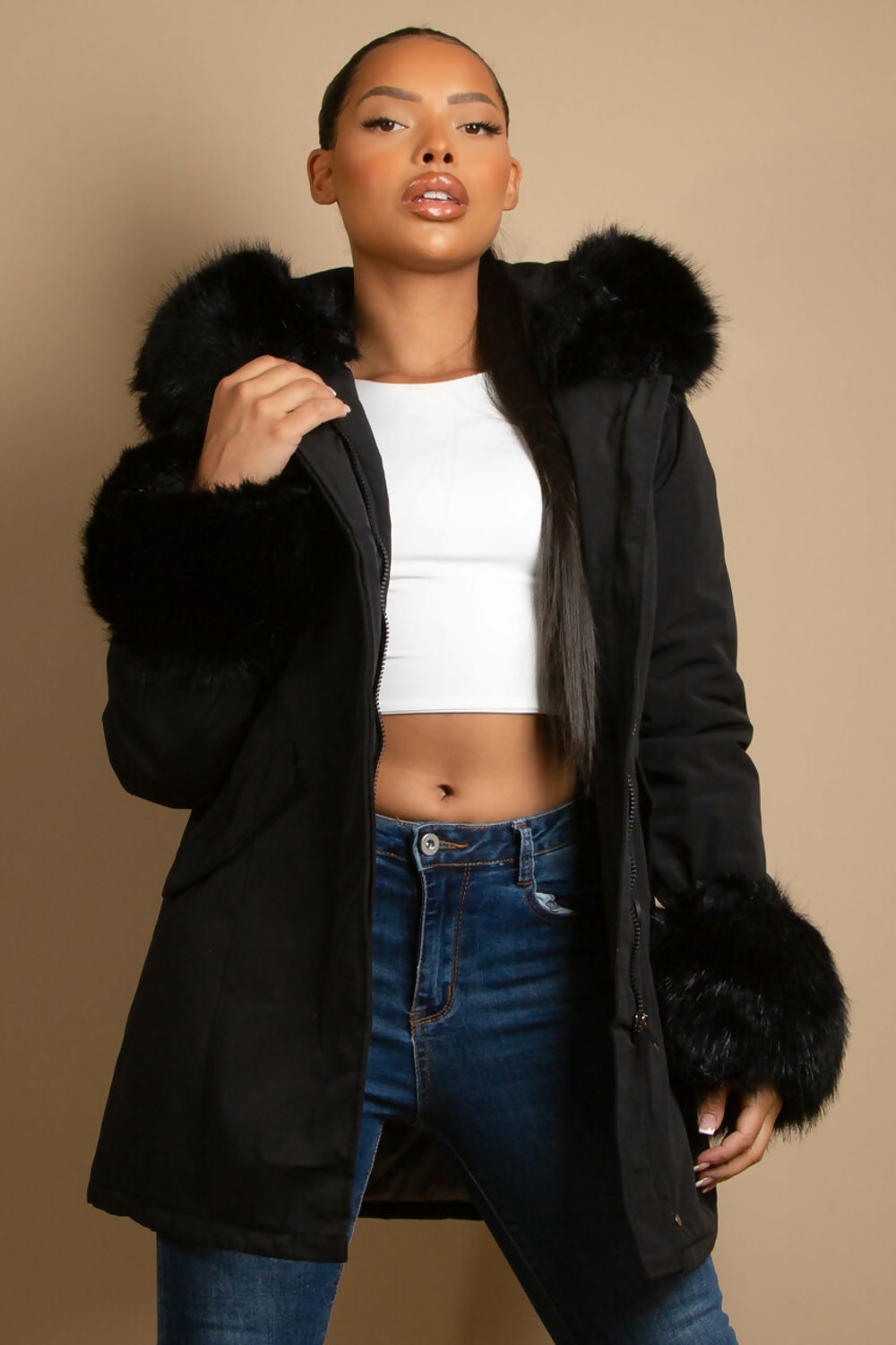 A stylish hooded parka coat featuring chunky faux fur cuffs and hood, perfect for winter layering.