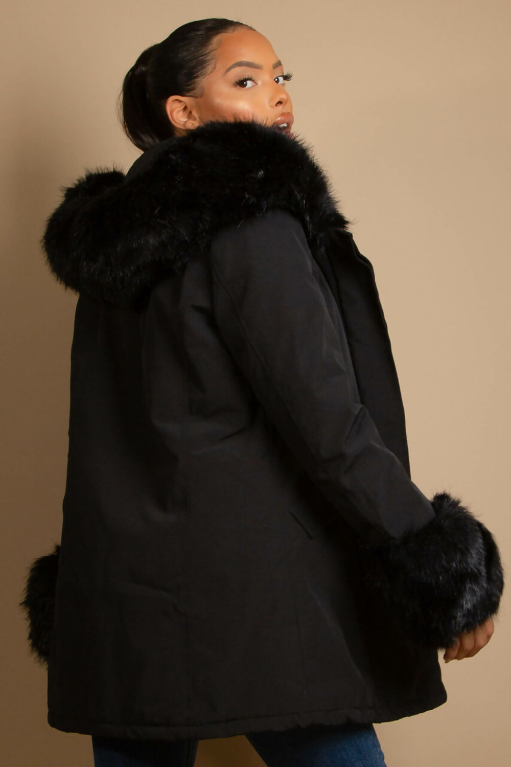 A stylish hooded parka coat featuring chunky faux fur cuffs and hood, perfect for winter layering.