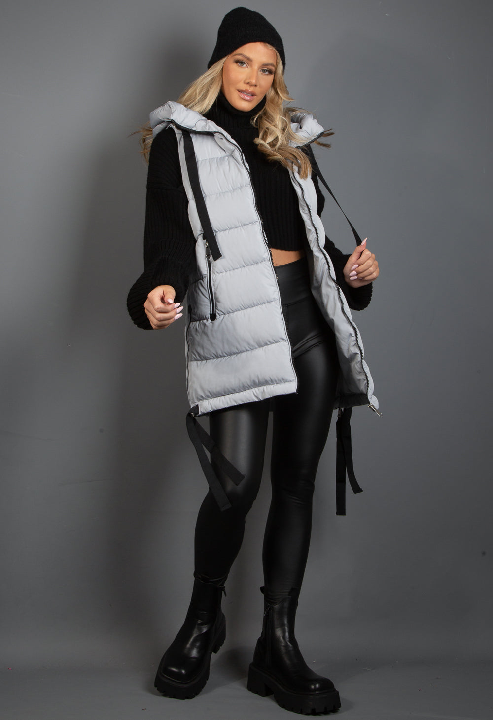 Hooded puffer gilet with webbing detail, featuring a zip-up closure and side zipped pockets, perfect for stylish warmth.