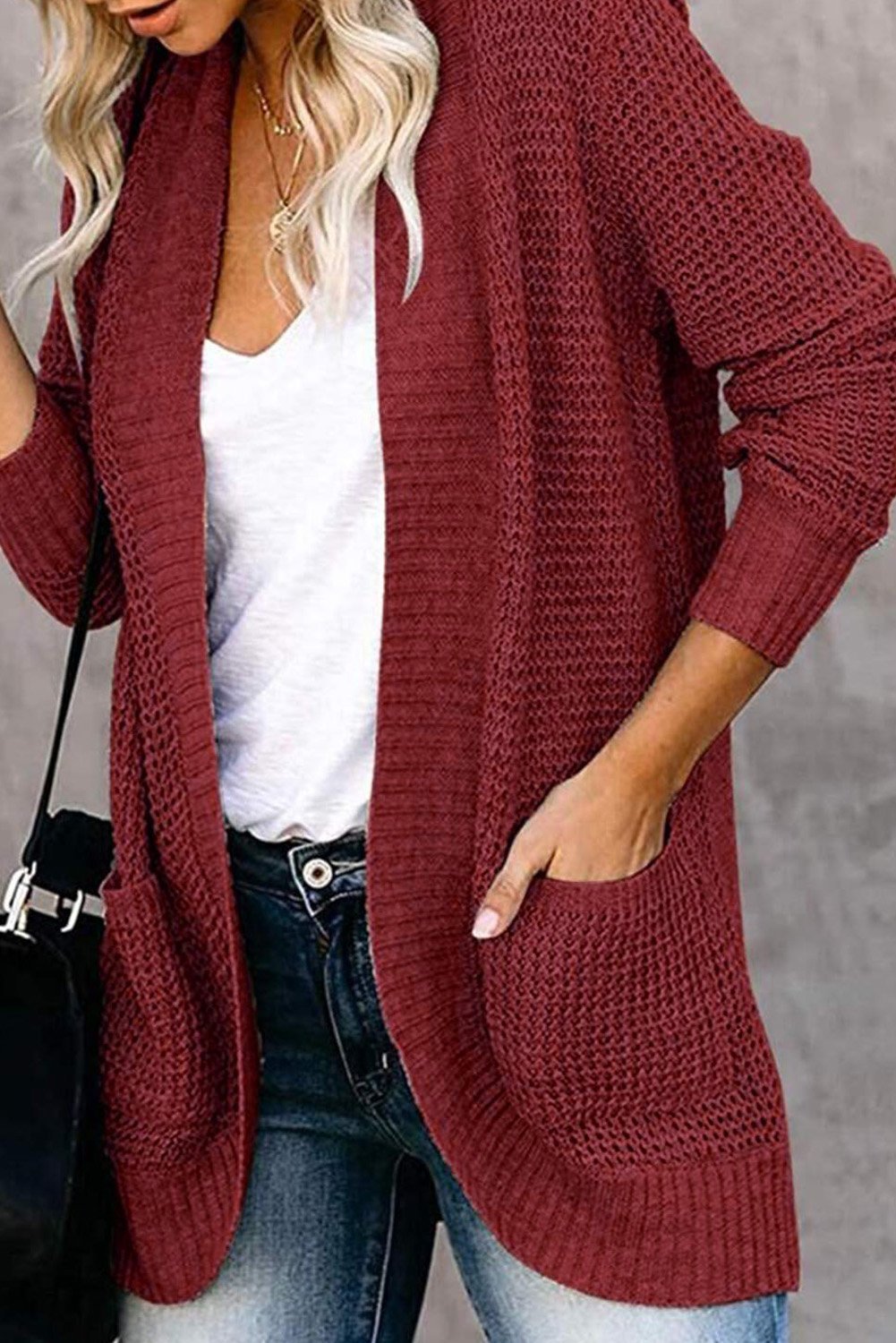 A stylish Pocket Knitted Solid Color Cardigan featuring a fuzzy texture and arc-shaped hem, perfect for layering over casual outfits.
