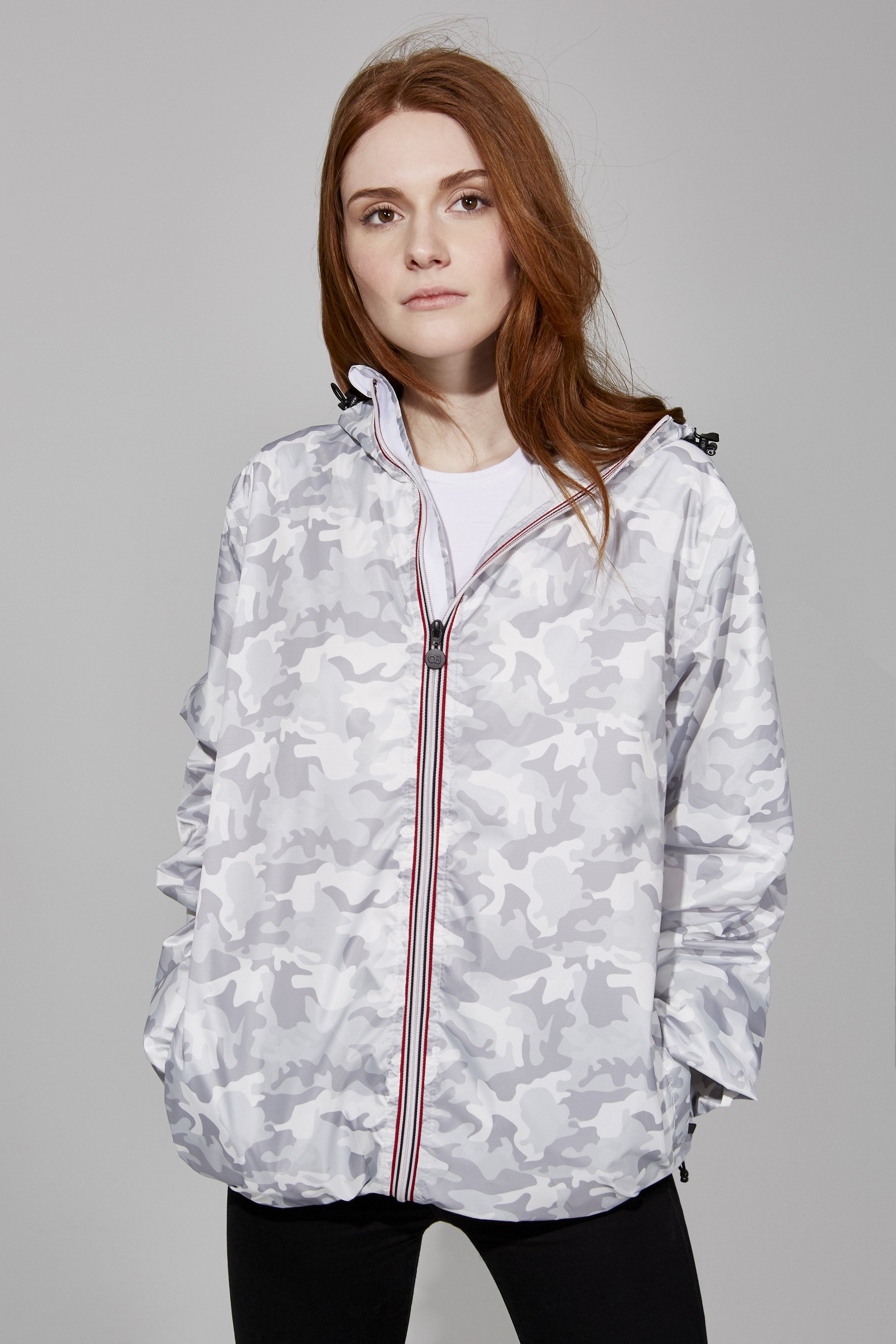 White camo full zip packable rain jacket displayed on a hanger, showcasing its stylish design and functional features.