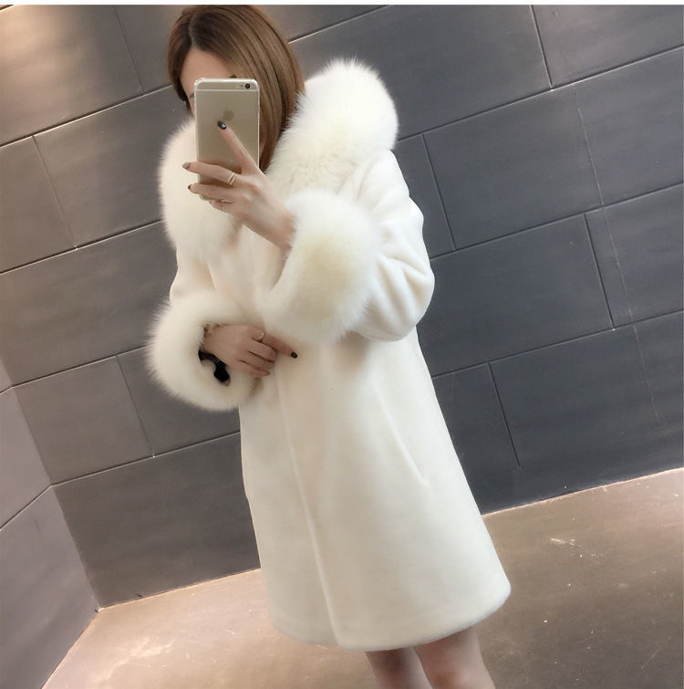 A stylish women's winter coat made of faux fur, featuring a hood and mid-length design, perfect for cold weather.