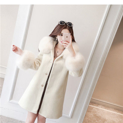 A stylish women's winter coat made of faux fur, featuring a hood and mid-length design, perfect for cold weather.