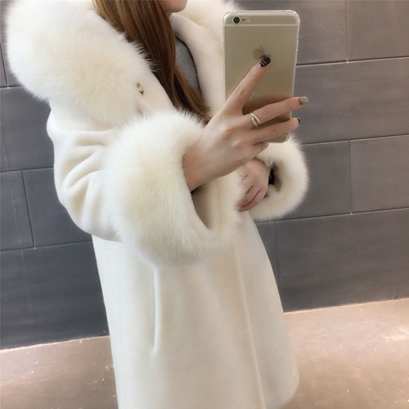 A stylish women's winter coat made of faux fur, featuring a hood and mid-length design, perfect for cold weather.