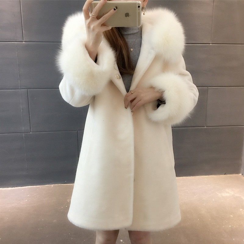 A stylish women's winter coat made of faux fur, featuring a hood and mid-length design, perfect for cold weather.