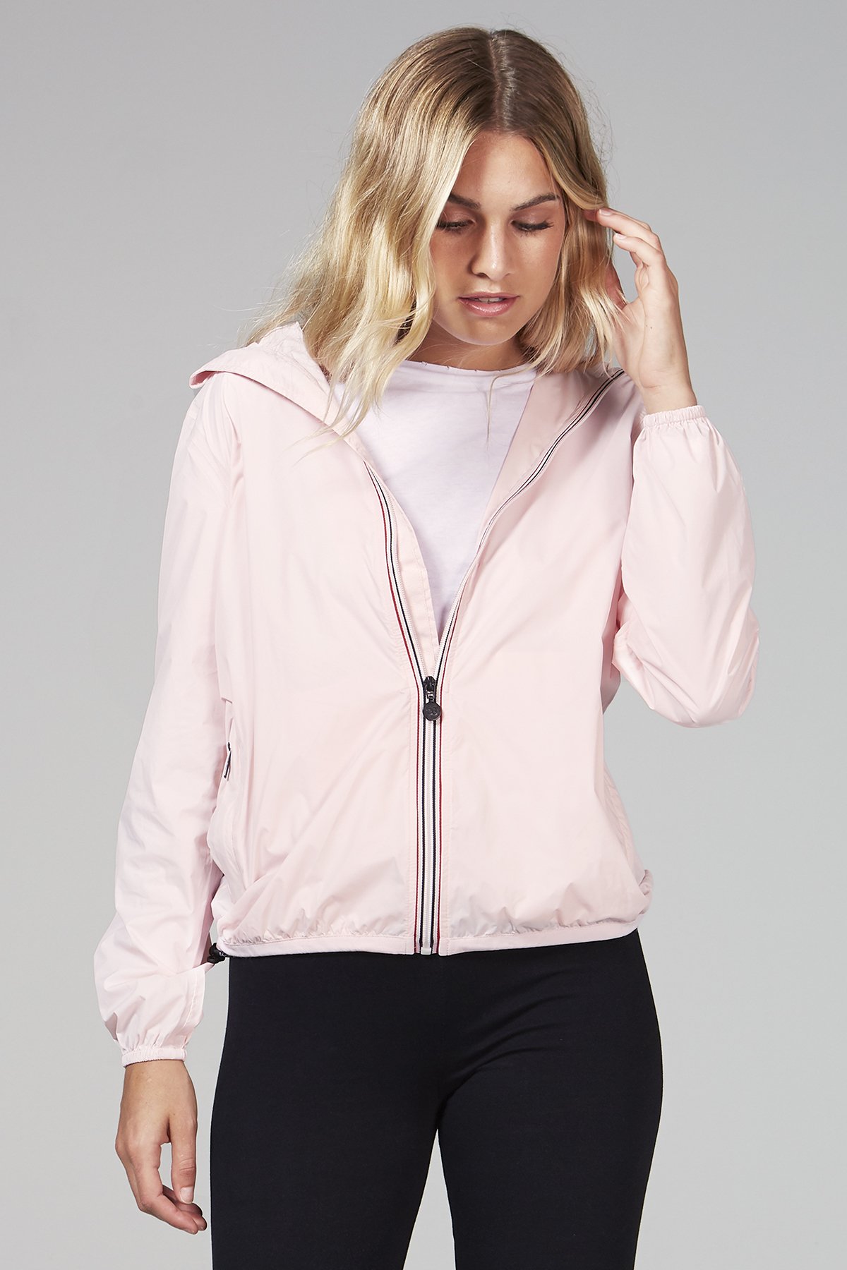 A stylish women's ballet slipper full zip packable rain jacket in a vibrant color, showcasing its waterproof fabric and compact design.