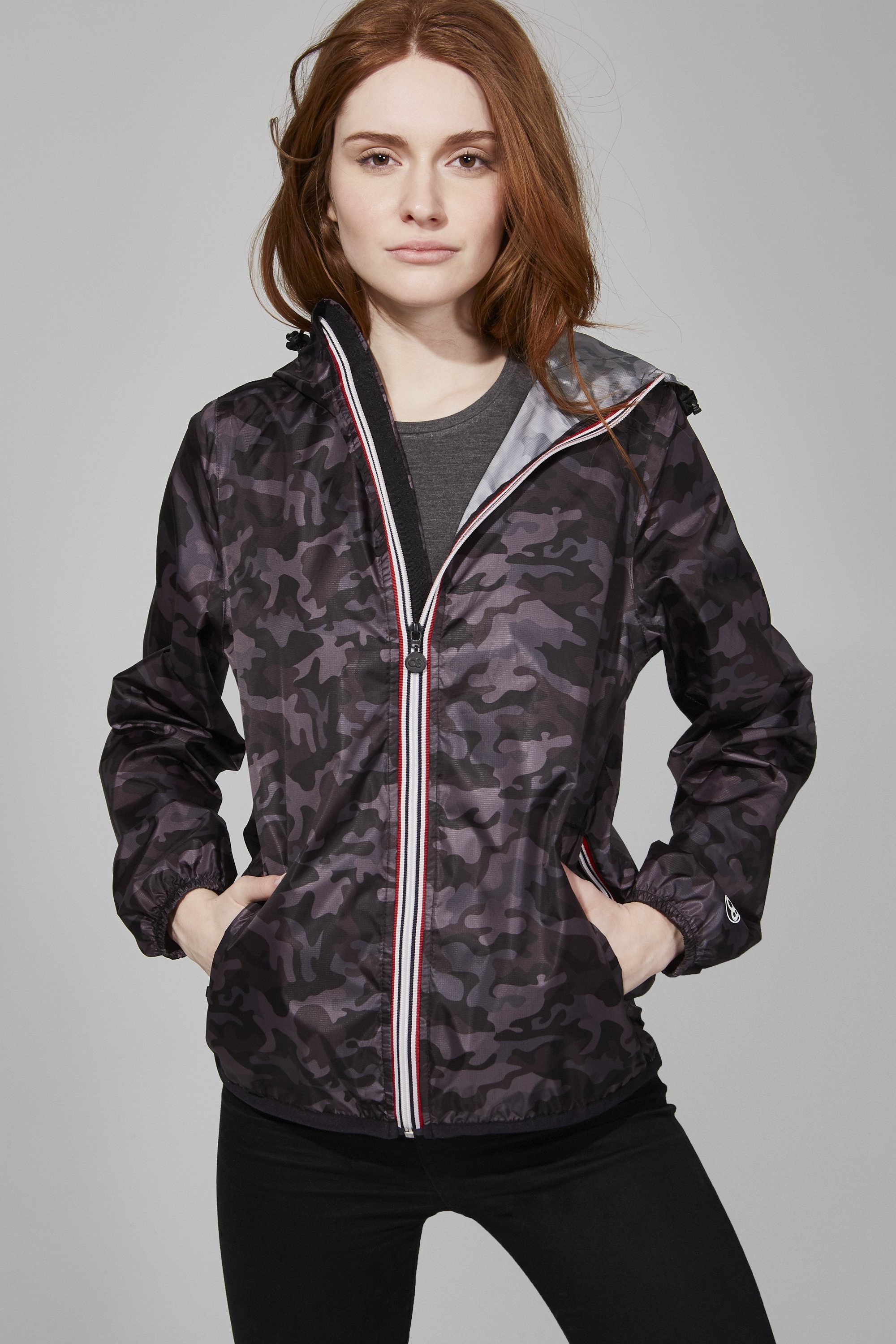 Women's black camo full zip packable rain jacket displayed on a mannequin, showcasing its stylish design and packable feature.