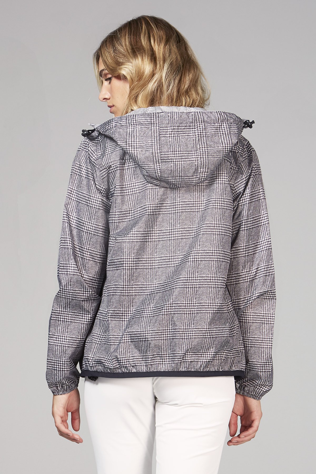 Women's plaid full zip packable rain jacket in a stylish design, featuring an ergonomic hood and hidden side pockets.