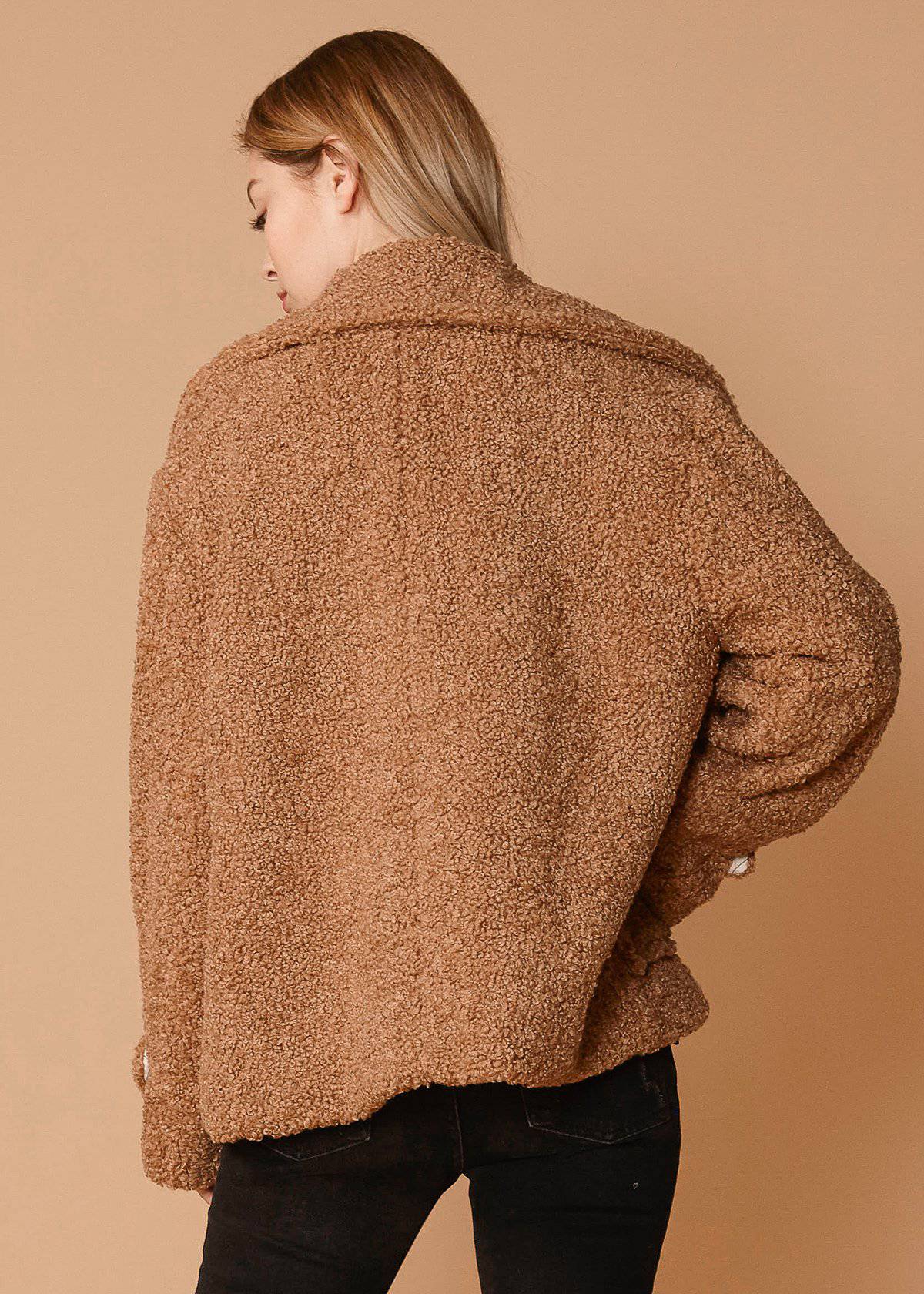 Women's brown faux shearling coat with two front pockets, lined interior, and stylish design.