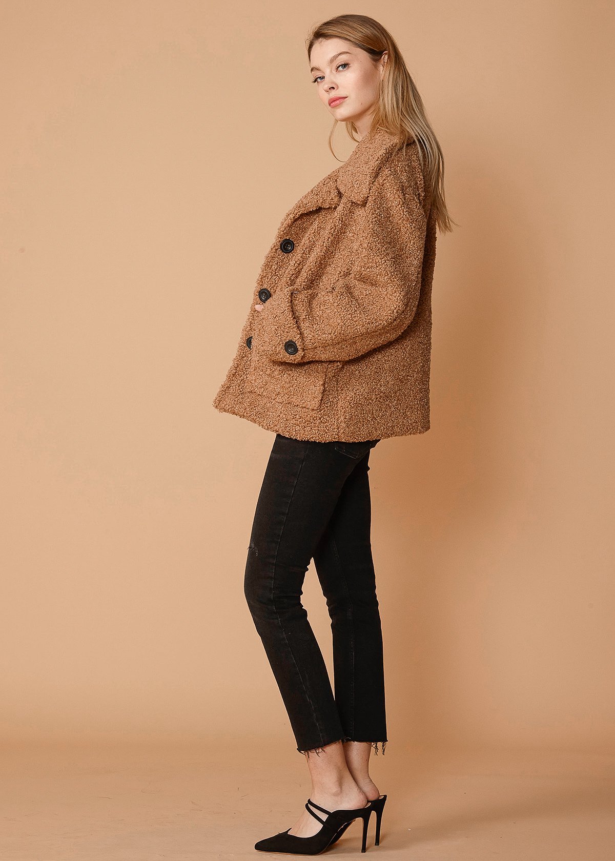 Women's brown faux shearling coat with two front pockets, lined interior, and stylish design.