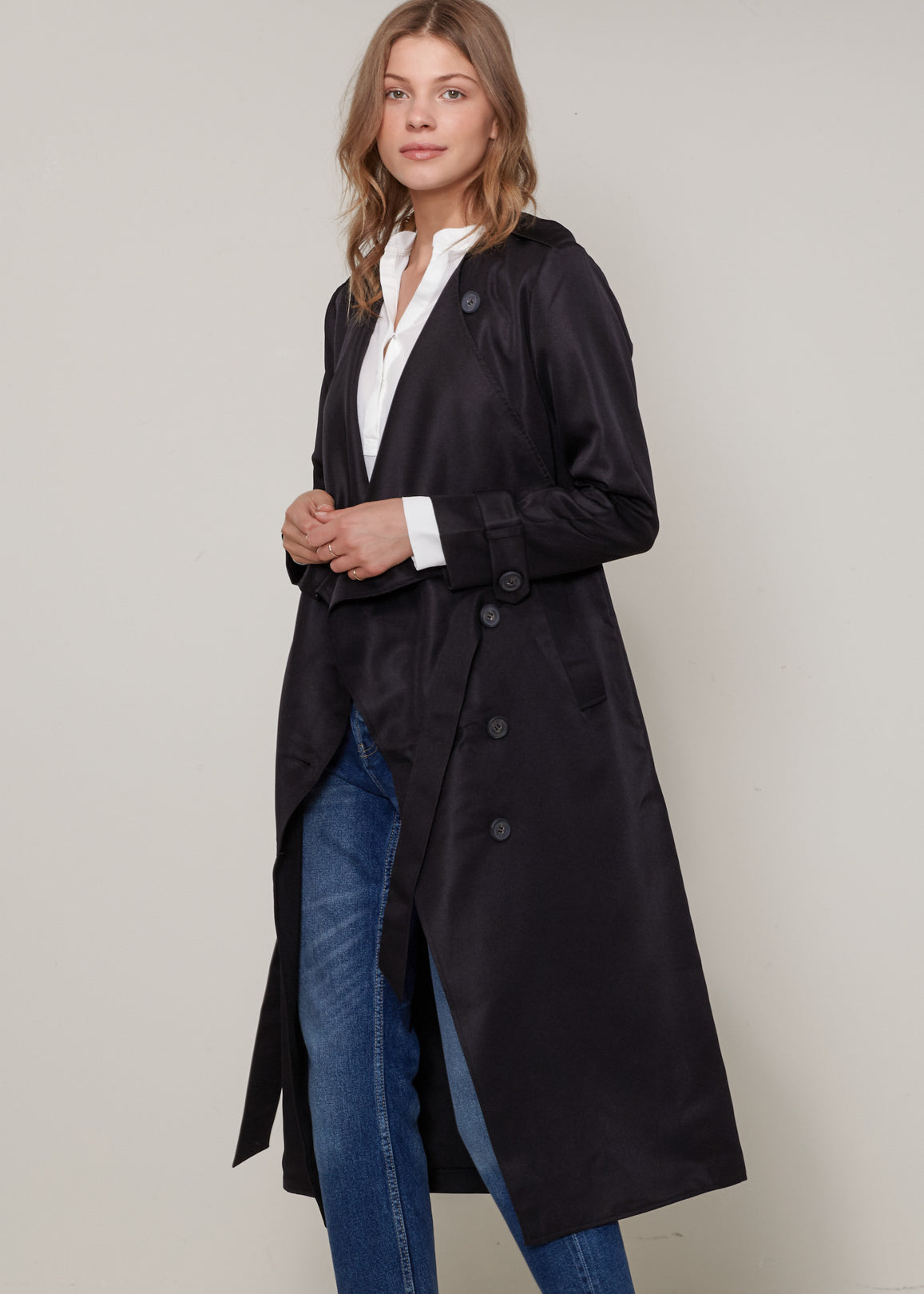Women's Tie Waist Maxi Trench Coat featuring a grid print and PU leather tassel, styled elegantly on a model.