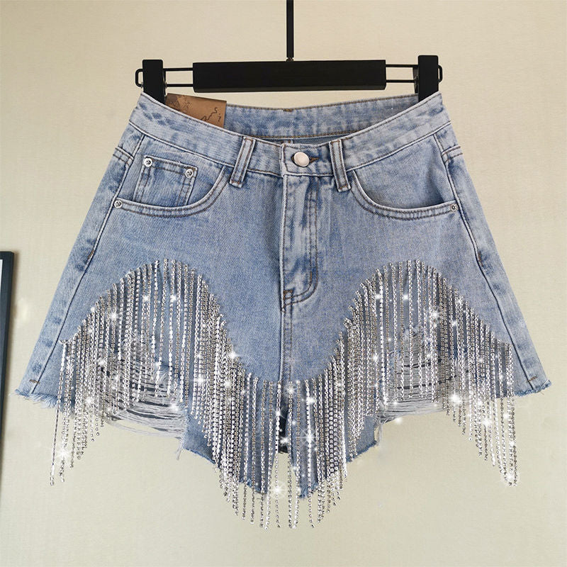 A pair of stylish summer ripped jeans shorts for women, featuring a high waist, diamond tassel decorations, and a casual ripped denim design in blue.