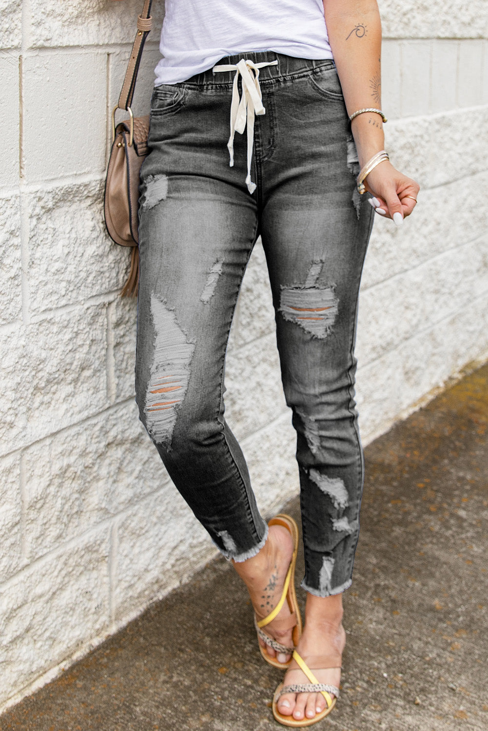 A pair of women's gray ripped jeans featuring a drawstring elastic waist, pockets, and a slim fit design, perfect for casual summer wear.