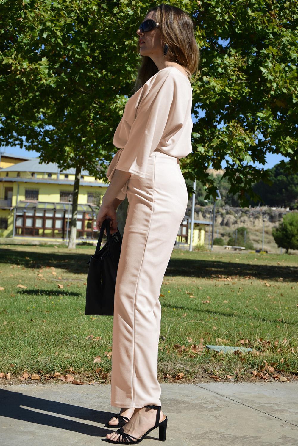 A stylish apricot jumpsuit featuring 3/4 sleeves, a waist tie sash, and wide-leg design, perfect for casual and formal occasions.