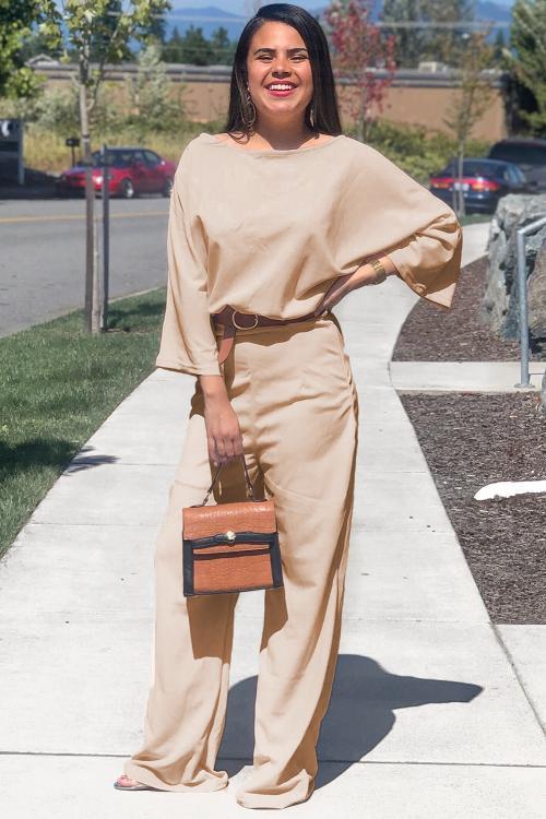 A stylish apricot jumpsuit featuring 3/4 sleeves, a waist tie sash, and wide-leg design, perfect for casual and formal occasions.