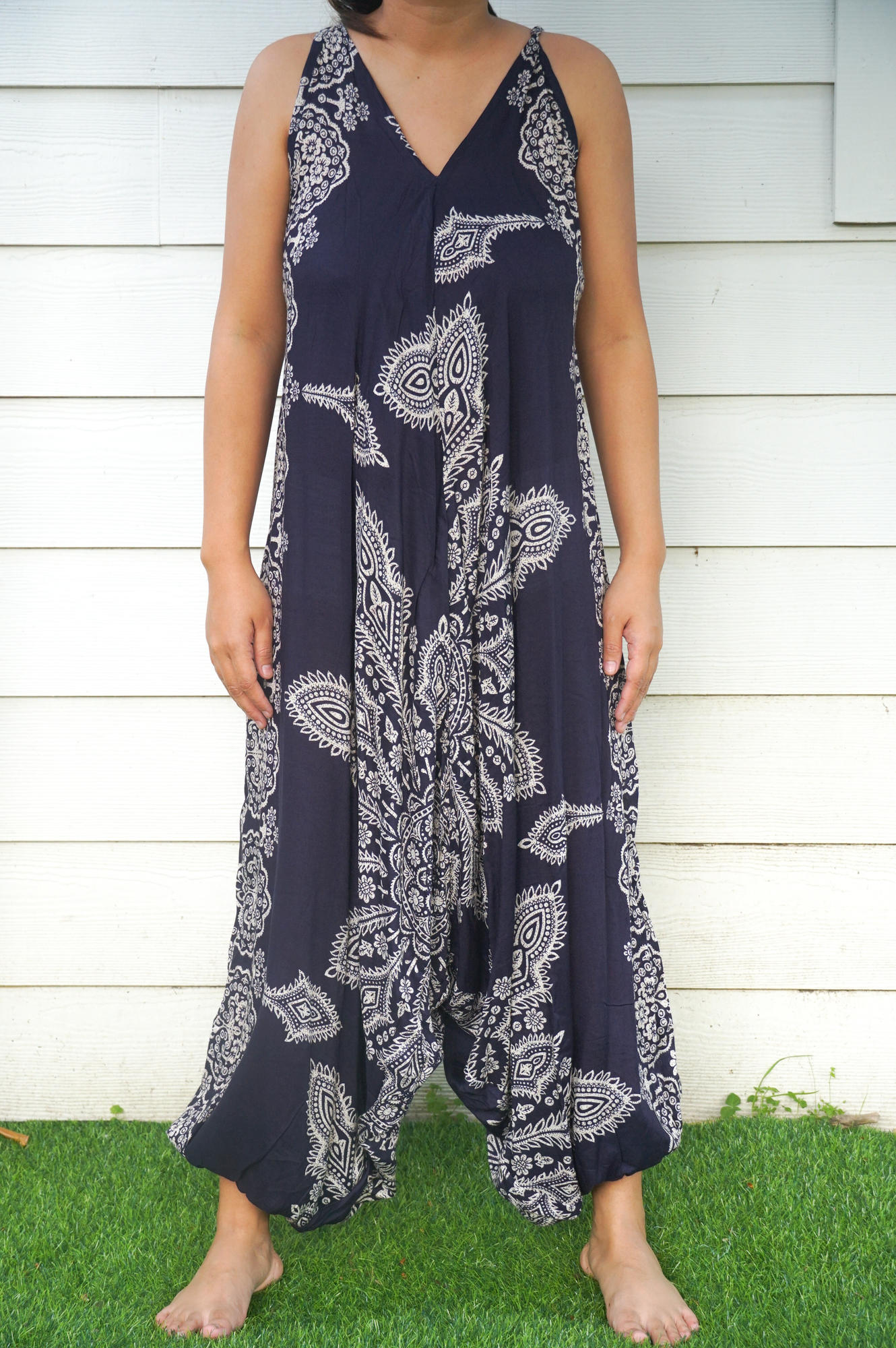 A vibrant blue butterfly hippie jumpsuit with wide legs, adjustable straps, and elasticated back, perfect for summer festivals.