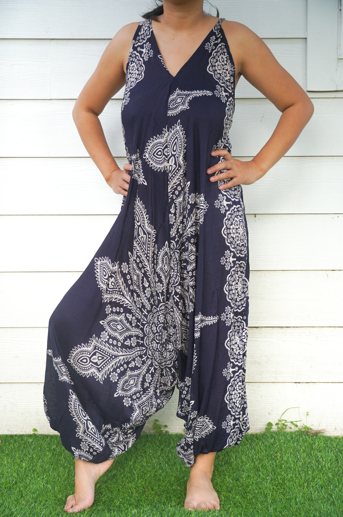 A vibrant blue butterfly hippie jumpsuit with wide legs, adjustable straps, and elasticated back, perfect for summer festivals.