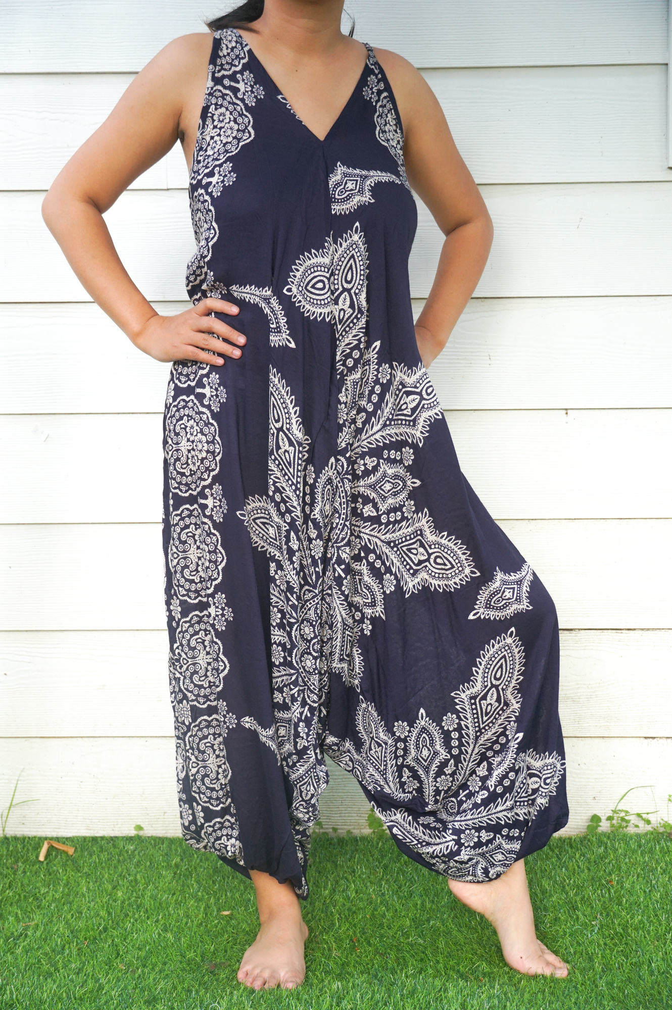 A vibrant blue butterfly hippie jumpsuit with wide legs, adjustable straps, and elasticated back, perfect for summer festivals.