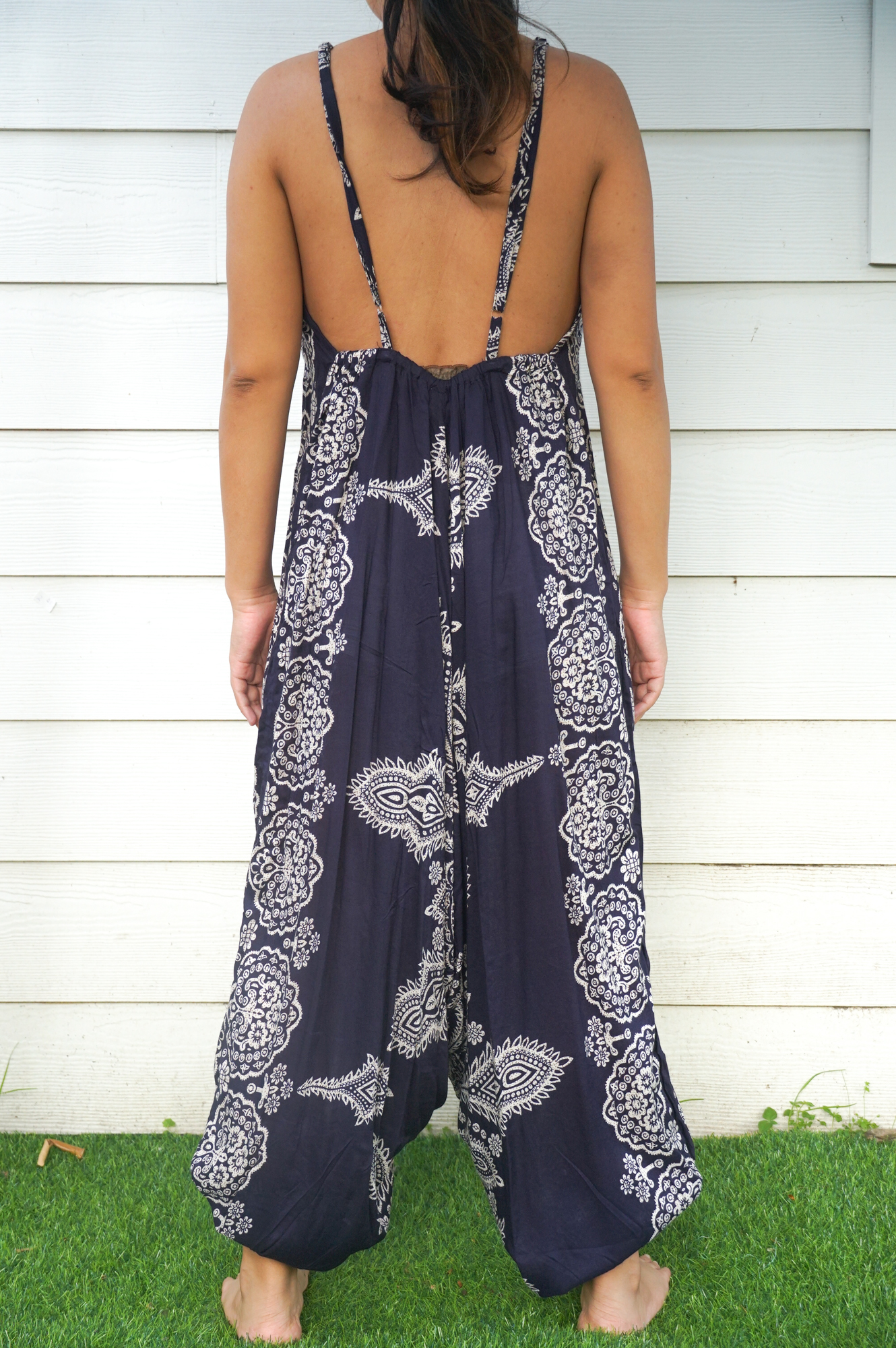A vibrant blue butterfly hippie jumpsuit with wide legs, adjustable straps, and elasticated back, perfect for summer festivals.