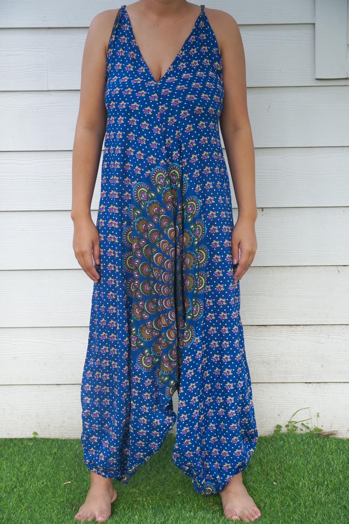 A vibrant Blue Chakra Hippie Jumpsuit featuring wide legs, adjustable straps, and an elasticated back, perfect for summer festivals and beach outings.