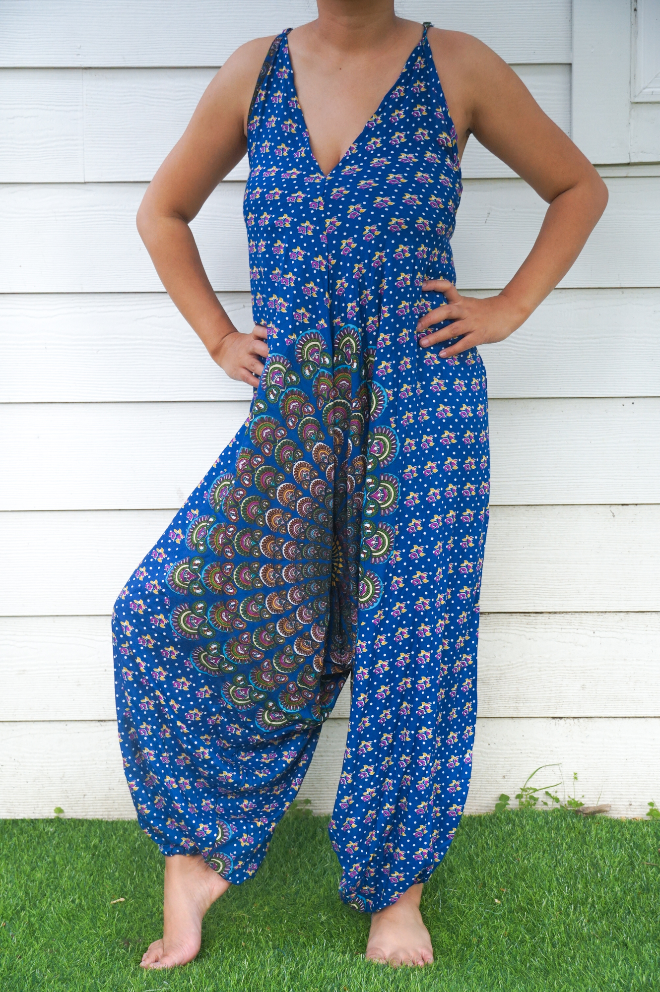 A vibrant Blue Chakra Hippie Jumpsuit featuring wide legs, adjustable straps, and an elasticated back, perfect for summer festivals and beach outings.