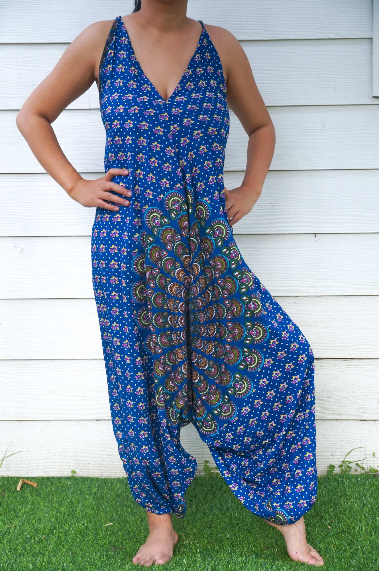 A vibrant Blue Chakra Hippie Jumpsuit featuring wide legs, adjustable straps, and an elasticated back, perfect for summer festivals and beach outings.