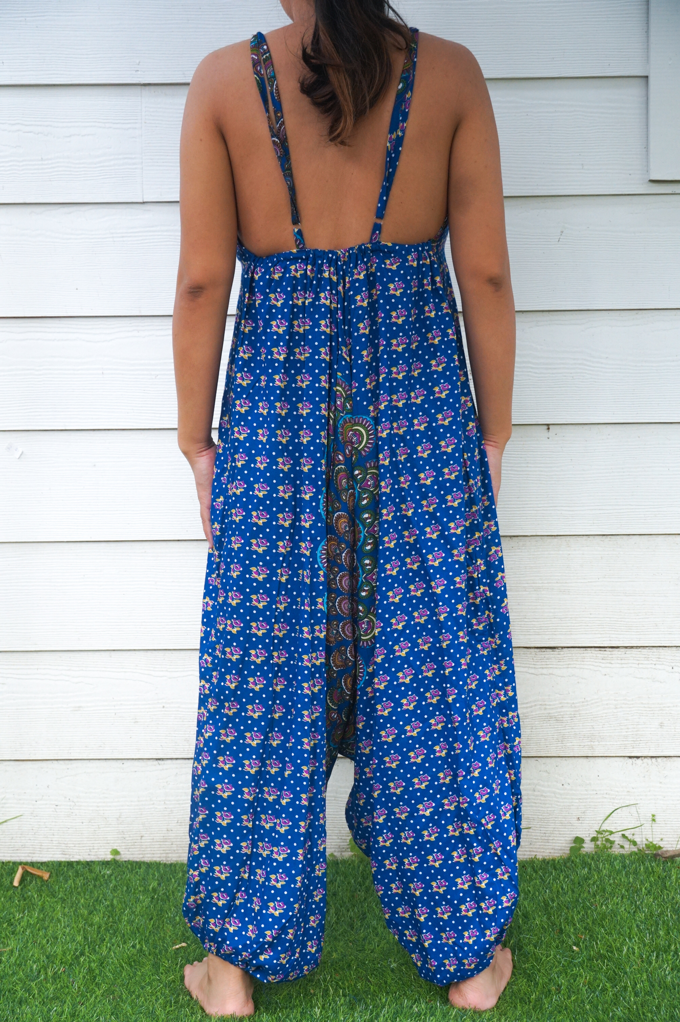 A vibrant Blue Chakra Hippie Jumpsuit featuring wide legs, adjustable straps, and an elasticated back, perfect for summer festivals and beach outings.