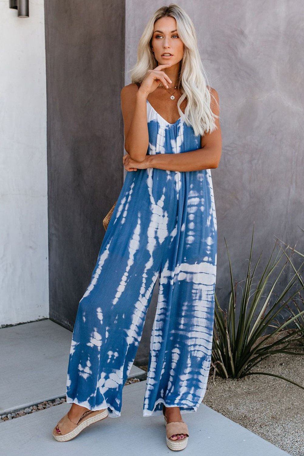 Casual blue spaghetti strap tie dye baggy long pants romper featuring a v-neck design and wide leg fit, perfect for summer wear.