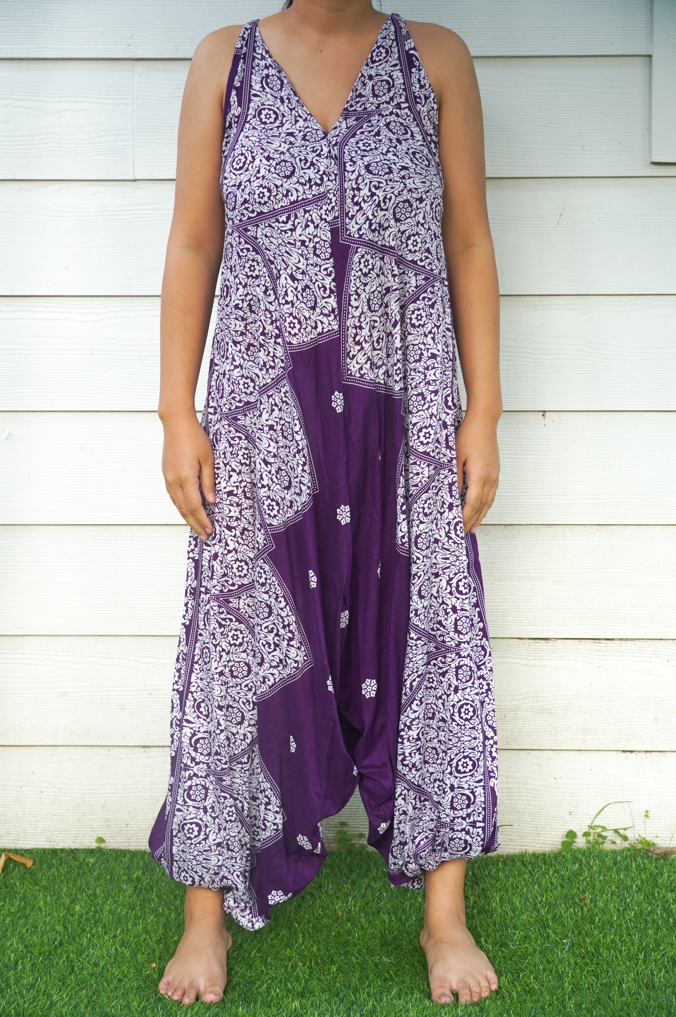 Purple Lotus Hippie Jumpsuit featuring a boho design with wide legs, adjustable straps, and vibrant patterns, perfect for summer festivals.