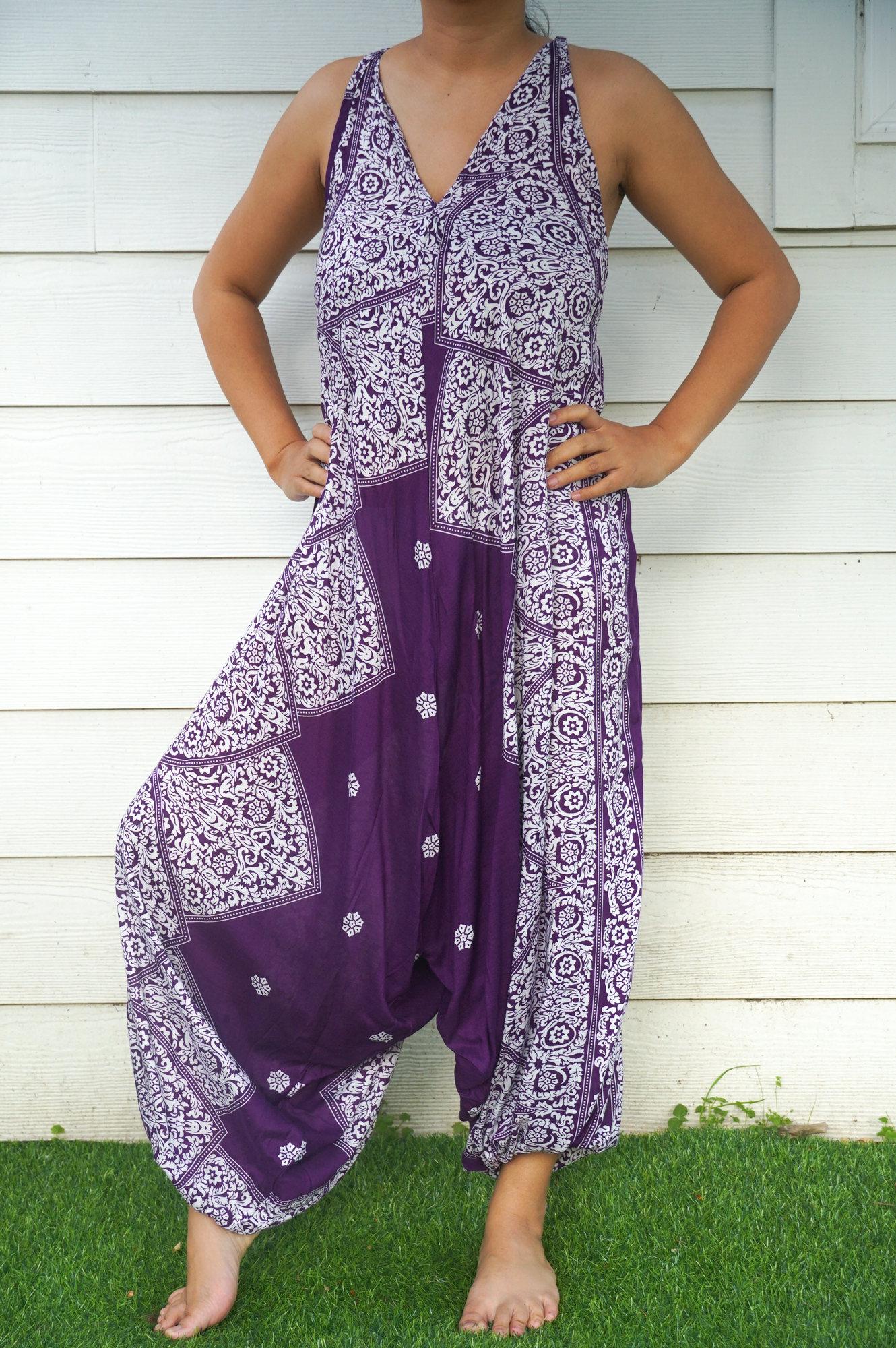 Purple Lotus Hippie Jumpsuit featuring a boho design with wide legs, adjustable straps, and vibrant patterns, perfect for summer festivals.