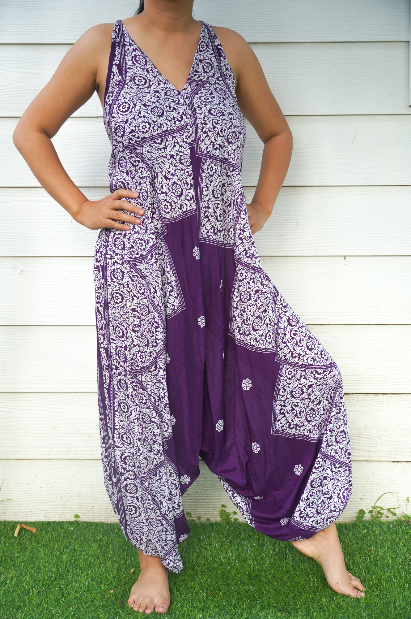 Purple Lotus Hippie Jumpsuit featuring a boho design with wide legs, adjustable straps, and vibrant patterns, perfect for summer festivals.