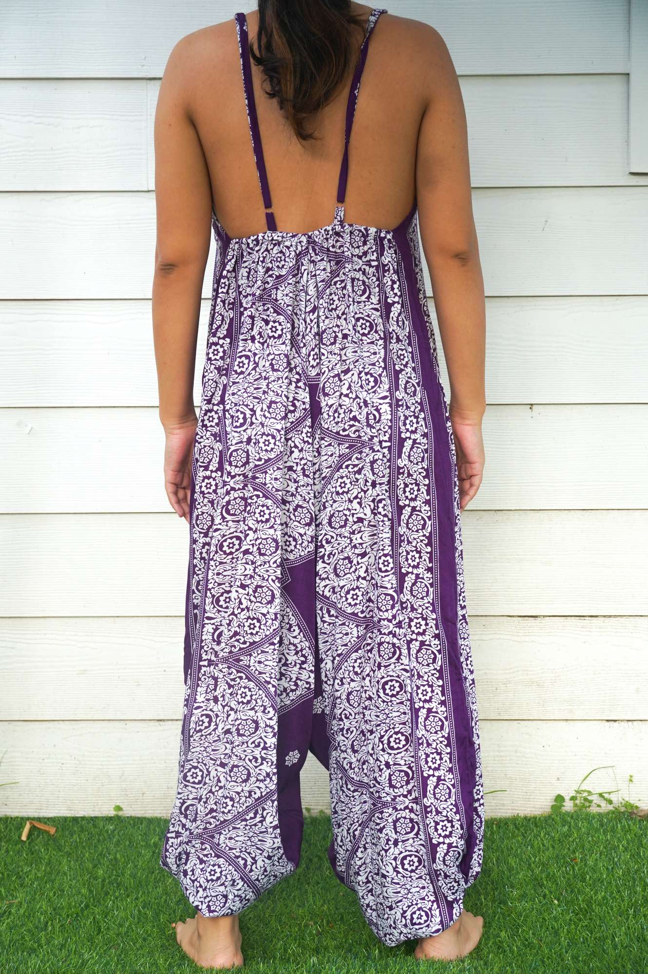 Purple Lotus Hippie Jumpsuit featuring a boho design with wide legs, adjustable straps, and vibrant patterns, perfect for summer festivals.