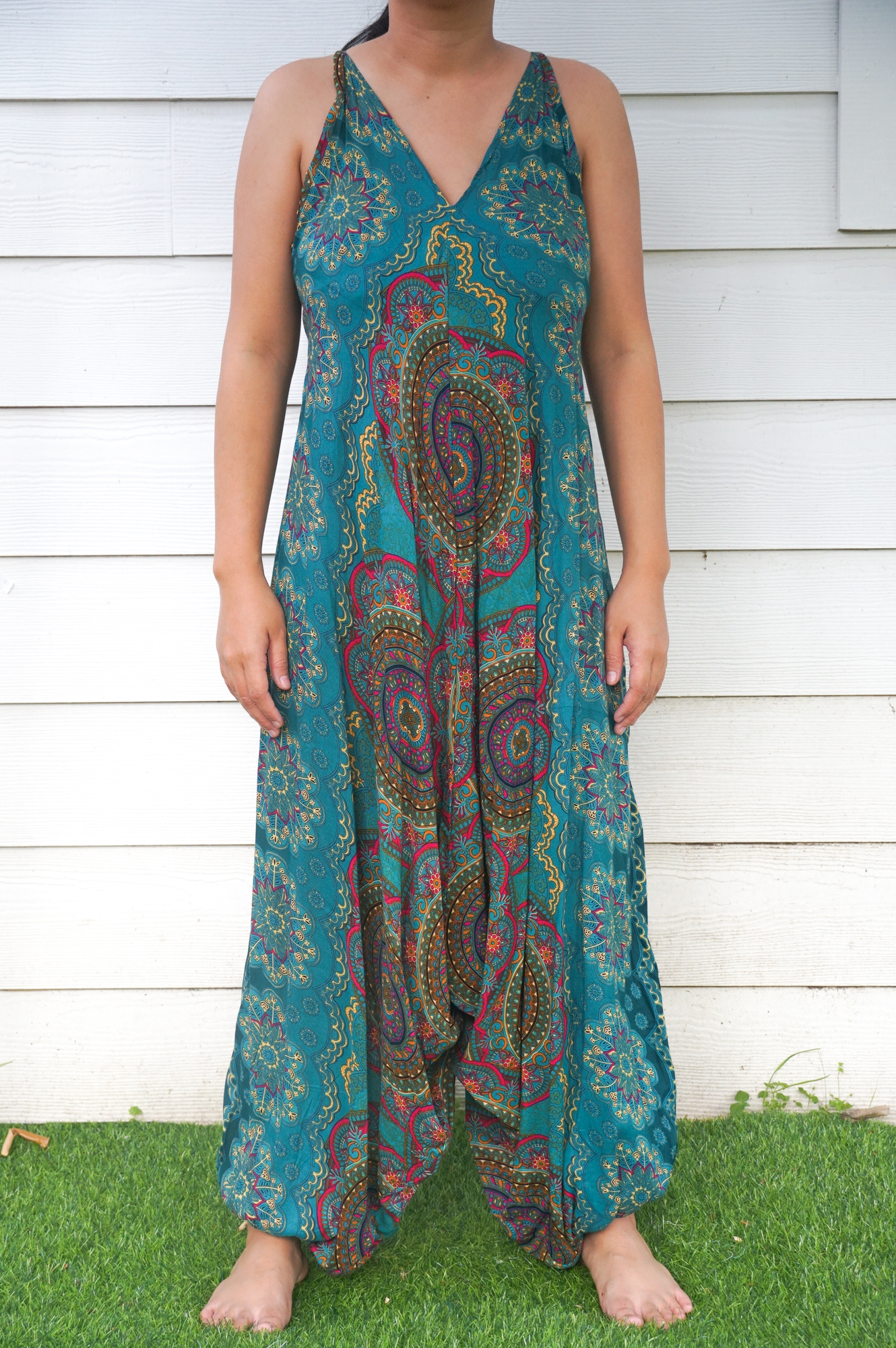 Teal Mandala Hippie Jumpsuit featuring vibrant patterns, adjustable straps, and wide legs, perfect for festivals and summer wear.