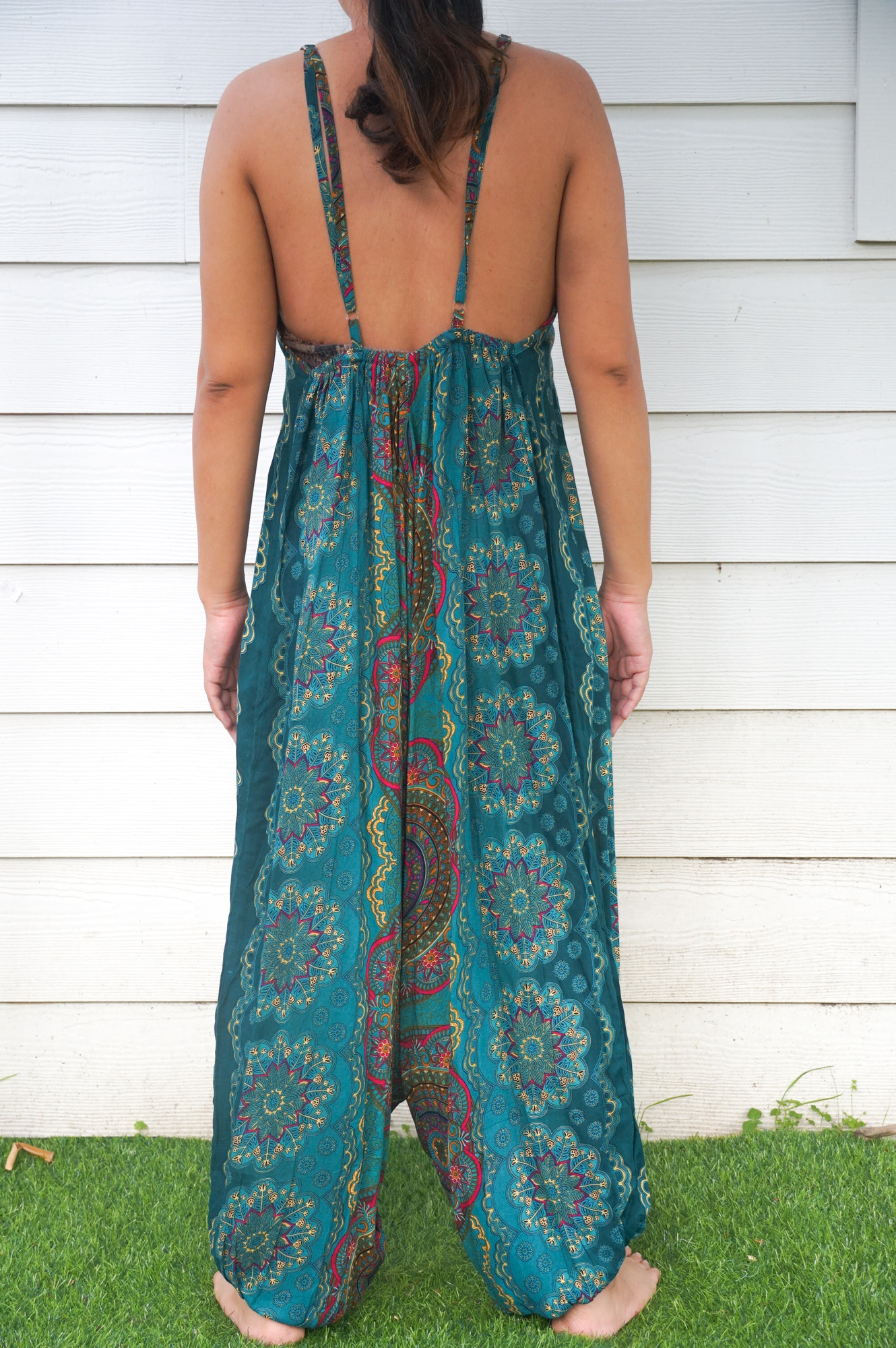 Teal Mandala Hippie Jumpsuit featuring vibrant patterns, adjustable straps, and wide legs, perfect for festivals and summer wear.