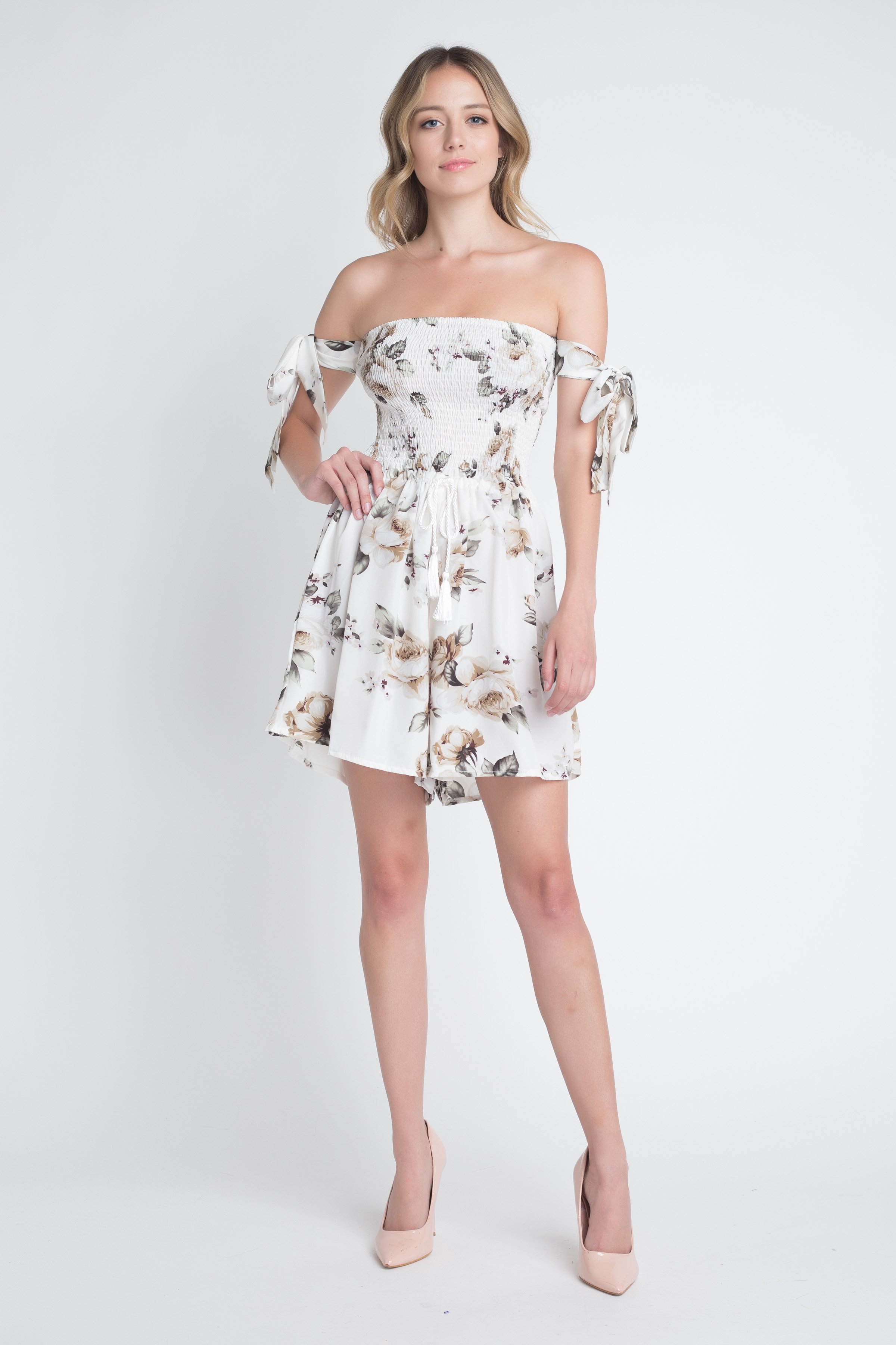 A stylish Women's Off Shoulder Smocked Floral Tie Romper featuring a vibrant floral print and adjustable tie sleeves, perfect for summer outings.