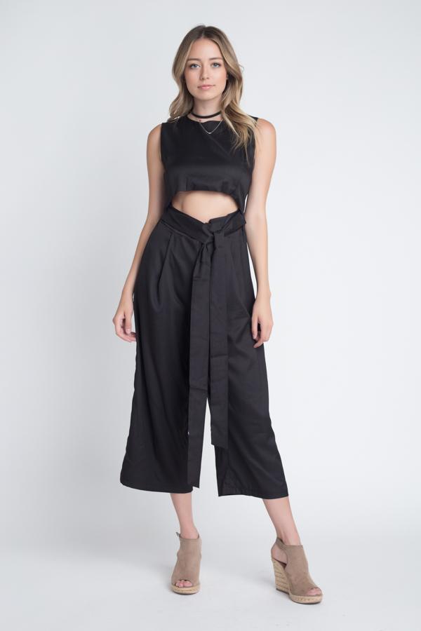 A stylish women's sleeveless tie jumpsuit featuring a chic slit, perfect for warm weather occasions.